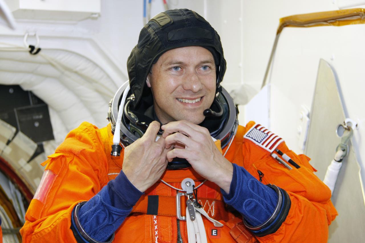 CAPE CANAVERAL, Fla. –  – In the White Room on the orbiter access arm of the fixed service structure on Launch Pad 39A at NASA's Kennedy Space Center in Florida, STS-127 Mission Specialist Tom Marshburn finishes suiting up before entering space shuttle Endeavour for the simulated launch countdown.  The crew is at Kennedy for a launch dress rehearsal called the terminal countdown demonstration test, or TCDT, which includes the simulation, emergency exit training and equipment familiarization.  Endeavour's STS-127 mission is the final of three flights dedicated to the assembly of the Japanese Kibo laboratory complex on the International Space Station.  Endeavour's launch is scheduled for June 13 at 7:17 a.m. EDT.  Photo credit: NASA/Troy Cryder