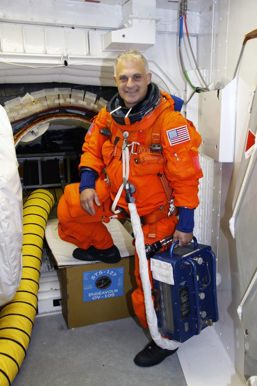 CAPE CANAVERAL, Fla. – In the White Room on the orbiter access arm of the fixed service structure on Launch Pad 39A at NASA's Kennedy Space Center in Florida, STS-127 Mission Specialist Dave Wolf is ready to enter space shuttle Endeavour for the simulated launch countdown. The crew is at Kennedy for a launch dress rehearsal called the terminal countdown demonstration test, or TCDT, which includes the simulation, emergency exit training and equipment familiarization.  Endeavour's STS-127 mission is the final of three flights dedicated to the assembly of the Japanese Kibo laboratory complex on the International Space Station.  Endeavour's launch is scheduled for June 13 at 7:17 a.m. EDT.  Photo credit: NASA/Troy Cryder