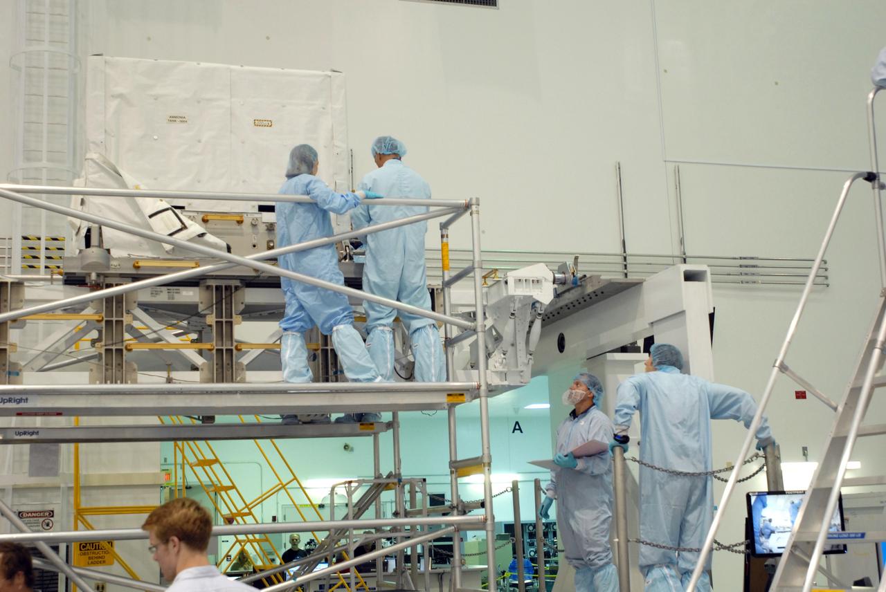 CAPE CANAVERAL, Fla. – In the Space Station Processing Facility at NASA's Kennedy Space Center in Florida, STS-128 Mission Specialists John "Danny" Olivas (top right) and Christer Fugelsang (bottom right) inspect ammonia tanks, part of the payload for their mission.  Members of the STS-128 crew are at Kennedy for a crew equipment interface test, or CEIT, which provides hands-on training and observation of shuttle and flight hardware. The STS-128 flight will carry science and storage racks to the International Space Station on space shuttle Discovery. The STS-128 mission is targeted to launch on Aug. 6. Photo credit: NASA/Jim Grossmann