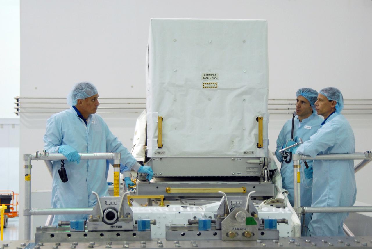 CAPE CANAVERAL, Fla. – In the Space Station Processing Facility at NASA's Kennedy Space Center in Florida, STS-128 Mission Specialists John "Danny" Olivas (left) and Christer Fugelsang (far right) inspect ammonia tanks, part of the payload for their mission.  Fugelsang is with the European Space Agency.  Members of the STS-128 crew are at Kennedy for a crew equipment interface test, or CEIT, which provides hands-on training and observation of shuttle and flight hardware. The STS-128 flight will carry science and storage racks to the International Space Station on space shuttle Discovery. The STS-128 mission is targeted to launch on Aug. 6. Photo credit: NASA/Jim Grossmann