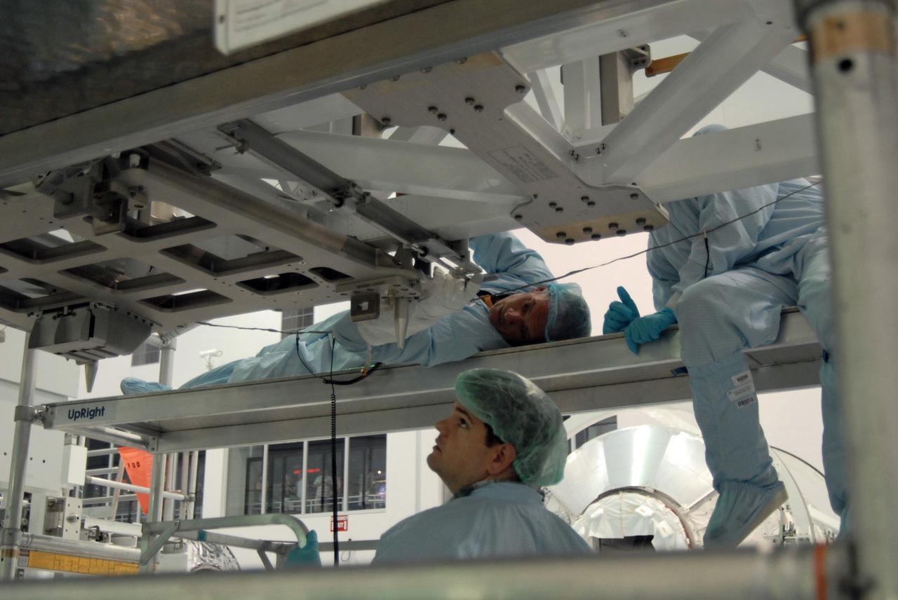 CAPE CANAVERAL, Fla. – In the Space Station Processing Facility at NASA's Kennedy Space Center in Florida, STS-128 Mission Specialist John "Danny" Olivas lies on a carrier while unbolting equipment, a task required for the mission. Members of the STS-128 crew are at Kennedy for a crew equipment interface test, or CEIT, which provides hands-on training and observation of shuttle and flight hardware. The STS-128 flight will carry science and storage racks to the International Space Station on space shuttle Discovery. The STS-128 mission is targeted to launch on Aug. 6. Photo credit: NASA/Jim Grossmann