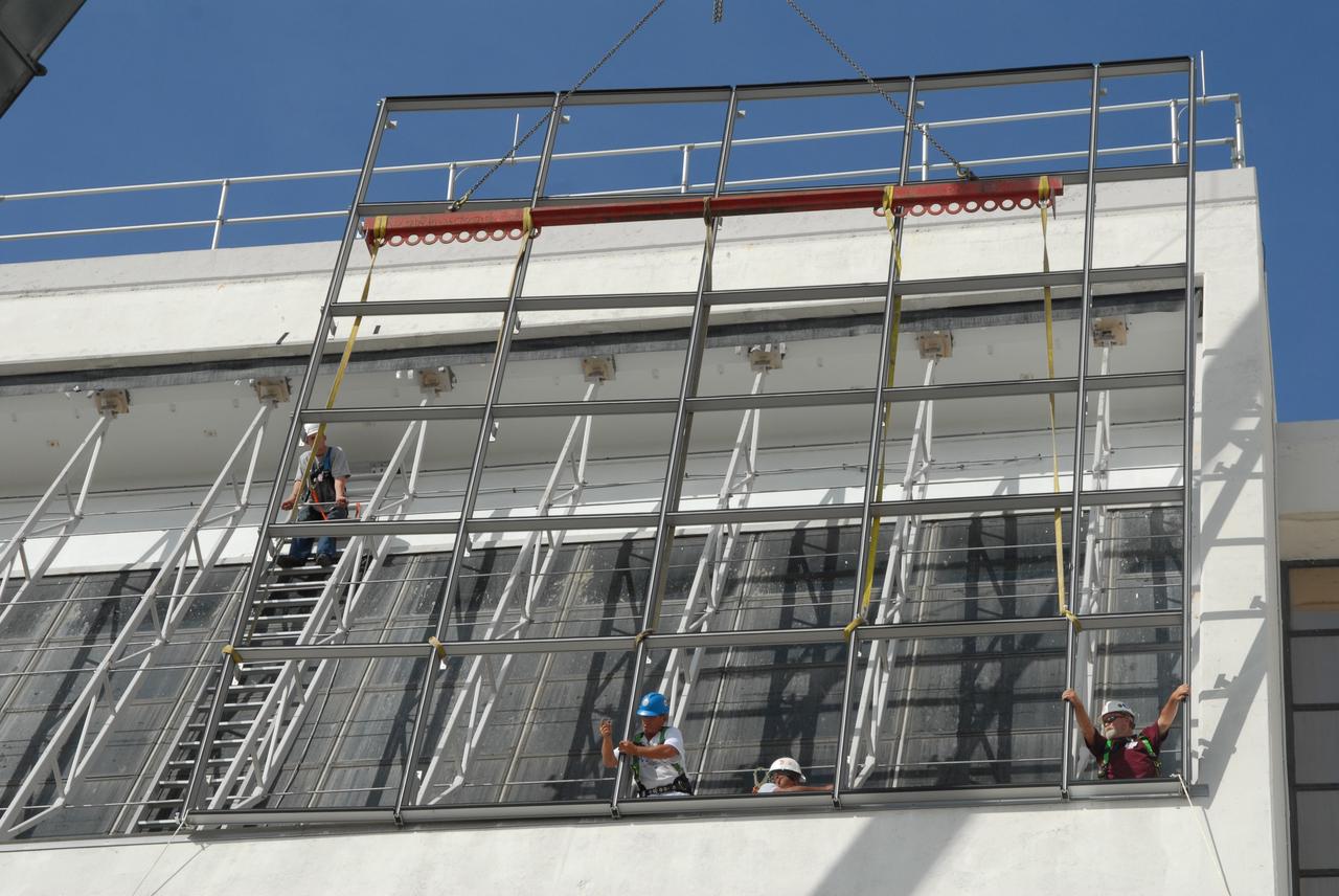 CAPE CANAVERAL, Fla. – At NASA's Kennedy Space Center in Florida, new, hurricane-rated window systems for the Launch Control Center's four Firing Rooms and the vestibule areas between Firing Rooms 1 & 2 and Firing Rooms 3 & 4 are being installed. In order to avoid operational impacts, the new windows are being installed on the outside of the existing windows, enclosing the space formerly occupied by the louvers, and the old windows will remain in place until the new windows are completely installed and leak tested. This approach will continue to keep the firing rooms from being exposed to the elements.  Photo credit: NASA/Tim Jacobs