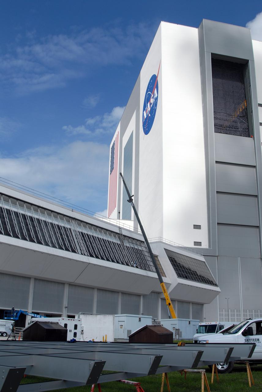 CAPE CANAVERAL, Fla. – At NASA's Kennedy Space Center in Florida, new, hurricane-rated window systems for the Launch Control Center's four Firing Rooms and the vestibule areas between Firing Rooms 1 & 2 and Firing Rooms 3 & 4 are being installed.  In order to avoid operational impacts, the new windows are being installed on the outside of the existing windows, enclosing the space formerly occupied by the louvers, and the old windows will remain in place until the new windows are completely installed and leak tested. This approach will continue to keep the firing rooms from being exposed to the elements.  Photo credit: NASA/Tim Jacobs