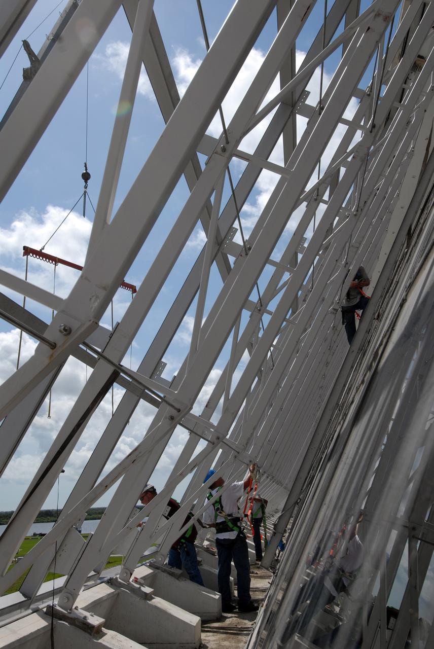 CAPE CANAVERAL, Fla. – At NASA's Kennedy Space Center in Florida, new, hurricane-rated window systems for the Launch Control Center's four Firing Rooms and the vestibule areas between Firing Rooms 1 & 2 and Firing Rooms 3 & 4 are being installed. In order to avoid operational impacts, the new windows are being installed on the outside of the existing windows, enclosing the space formerly occupied by the louvers, and the old windows will remain in place until the new windows are completely installed and leak tested. This approach will continue to keep the firing rooms from being exposed to the elements.  Photo credit: NASA/Tim Jacobs