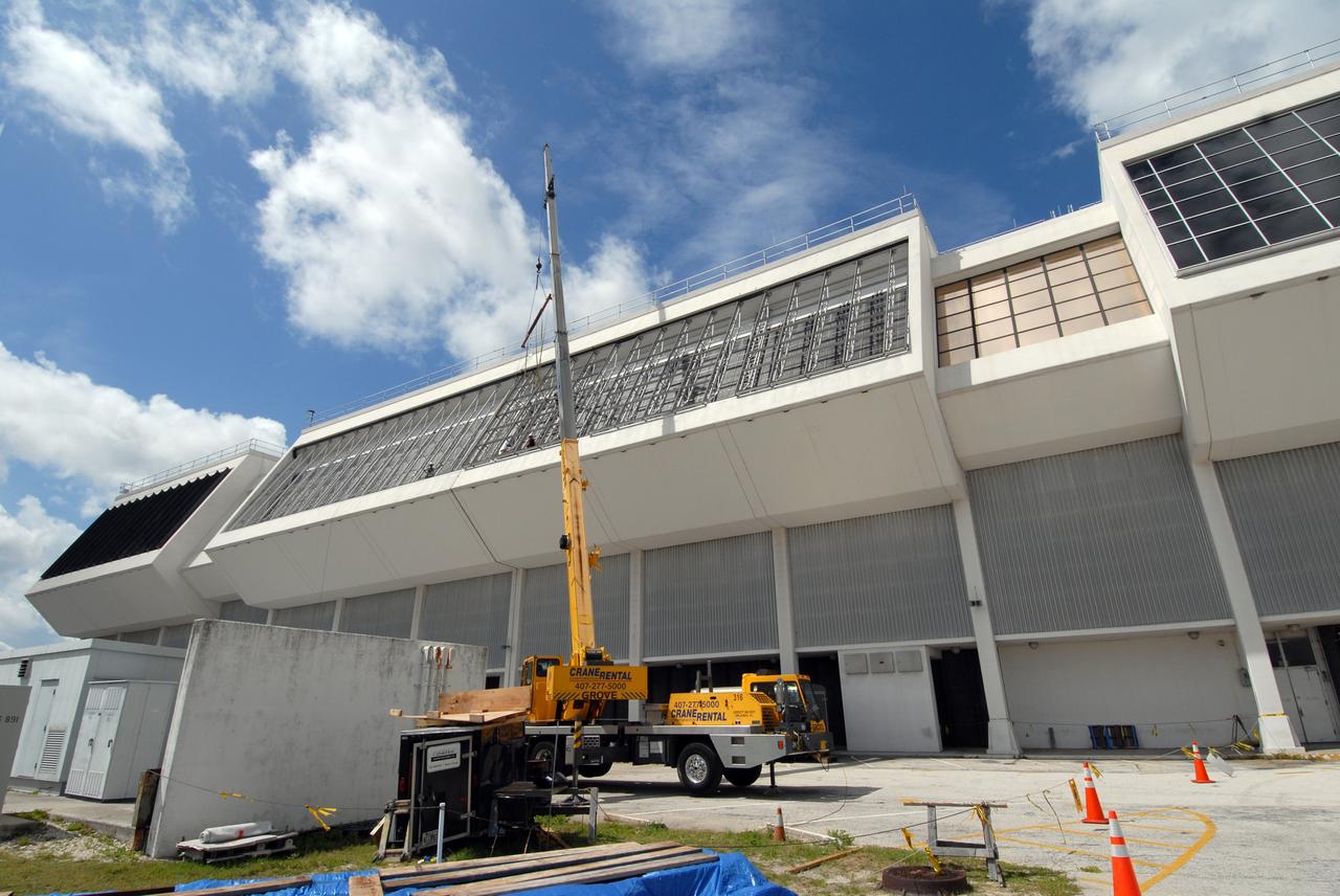 CAPE CANAVERAL, Fla. – At NASA's Kennedy Space Center in Florida, new, hurricane-rated window systems for the Launch Control Center's four Firing Rooms and the vestibule areas between Firing Rooms 1 & 2 and Firing Rooms 3 & 4 are being installed. In order to avoid operational impacts, the new windows are being installed on the outside of the existing windows, enclosing the space formerly occupied by the louvers, and the old windows will remain in place until the new windows are completely installed and leak tested. This approach will continue to keep the firing rooms from being exposed to the elements.  Photo credit: NASA/Tim Jacobs