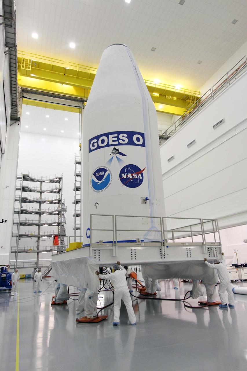 CAPE CANAVERAL, Fla. – At the Astrotech payload processing facility in Titusville, Fla., workers move the platform on which the encapsulated GOES-O satellite sits in preparation for moving GOES-O to  Cape Canaveral Air Force Station's Launch Complex 37 pad where it will be mated with the United Launch Alliance Delta IV expendable launch vehicle.  The GOES-O satellite is targeted to launch no earlier than June 26. The latest Geostationary Operational Environmental Satellite, GOES-O was developed by NASA for the National Oceanic and Atmospheric Administration, or NOAA. The GOES satellites continuously provide observations of 60 percent of the Earth including the continental United States, providing weather monitoring and forecast operations as well as a continuous and reliable stream of environmental information and severe weather warnings. Once in orbit, GOES-O will be designated GOES-14, and NASA will provide on-orbit checkout and then transfer operational responsibility to NOAA.  Photo credit: NASA/Jack Pfaller