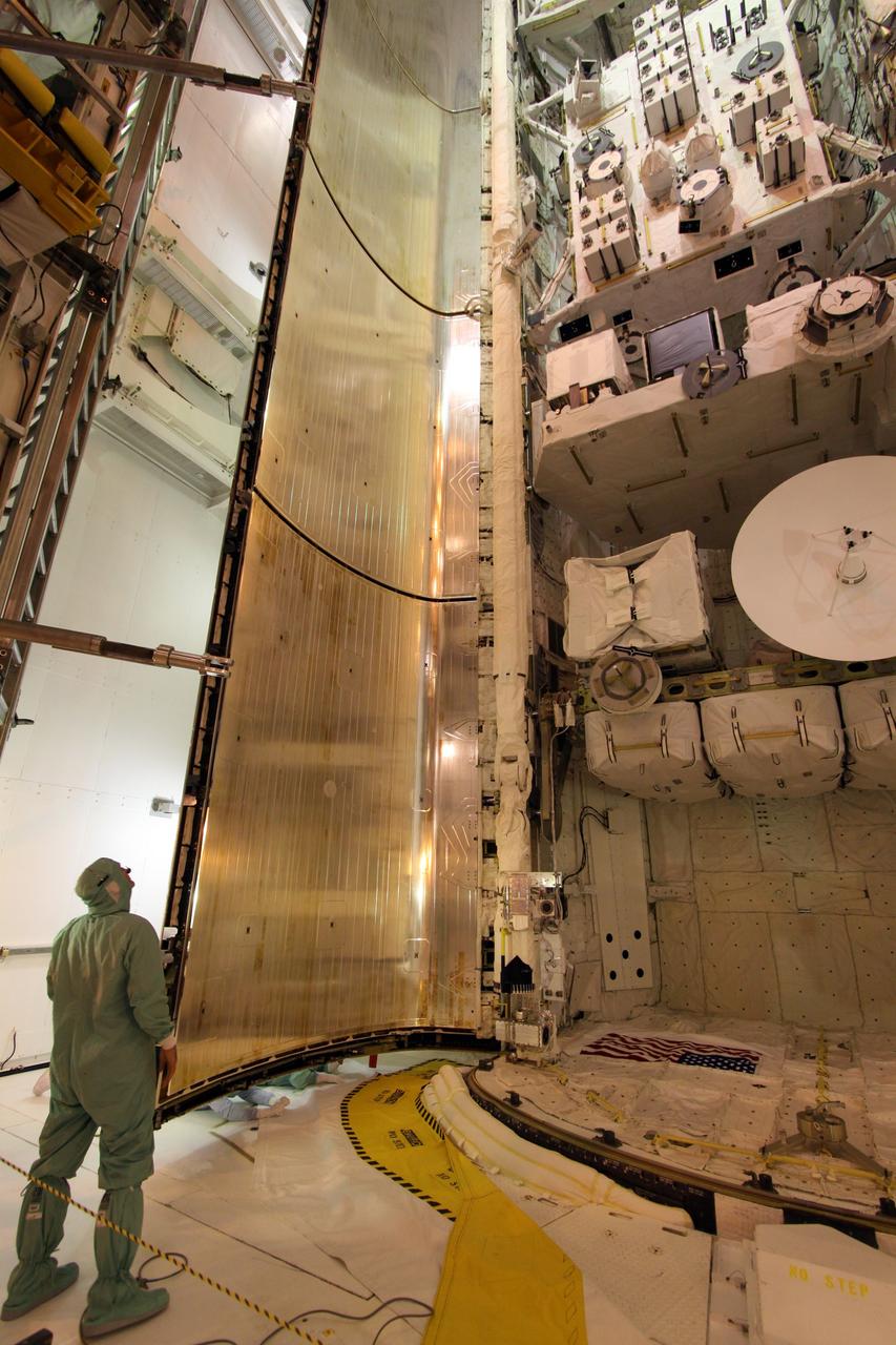 CAPE CANAVERAL, Fla. – On Launch Pad 39A at NASA's Kennedy Space Center in Florida, a worker keeps watch as the portside payload bay door closes over space shuttle Endeavour's payload. Inside are the Integrated Cargo Carrier-Vertical Light Deploy, the Experiment Logistics Module-Exposed Section and the Japanese Experiment Module's Exposed Facility. The STS-127 mission is the final of three flights dedicated to the assembly of the Japanese Kibo laboratory complex on the International Space Station. Photo credit: NASA/Jack Pfaller