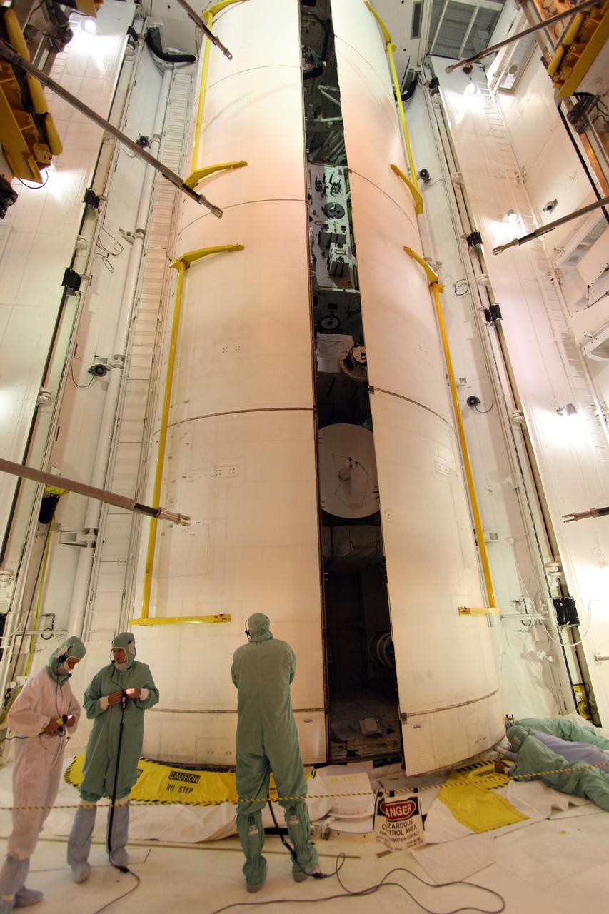 CAPE CANAVERAL, Fla. – On Launch Pad 39A at NASA's Kennedy Space Center in Florida, workers keep watch as space shuttle Endeavour's payload bay doors close. Inside are the Integrated Cargo Carrier-Vertical Light Deploy, the Experiment Logistics Module-Exposed Section and the Japanese Experiment Module's Exposed Facility.The STS-127 mission is the final of three flights dedicated to the assembly of the Japanese Kibo laboratory complex on the International Space Station. Photo credit: NASA/Jack Pfaller