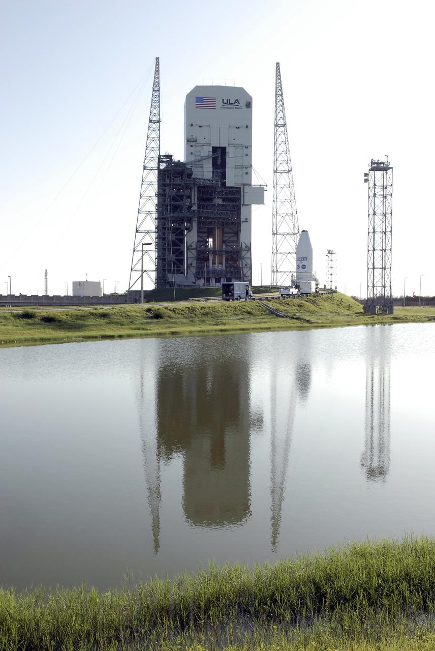 CAPE CANAVERAL, Fla. – Reflected in the pond at Cape Canaveral Air Force Station in Florida, the GOES-O satellite  arrives at Launch Complex 37.  There it will be lifted into the mobile service tower and mated with the United Launch Alliance Delta IV expendable launch vehicle.  The GOES-O satellite is targeted to launch no earlier than June 26. The latest Geostationary Operational Environmental Satellite, GOES-O was developed by NASA for the National Oceanic and Atmospheric Administration, or NOAA. The GOES satellites continuously provide observations of 60 percent of the Earth including the continental United States, providing weather monitoring and forecast operations as well as a continuous and reliable stream of environmental information and severe weather warnings. Once in orbit, GOES-O will be designated GOES-14, and NASA will provide on-orbit checkout and then transfer operational responsibility to NOAA.  Photo credit: NASA/Kim Shiflett