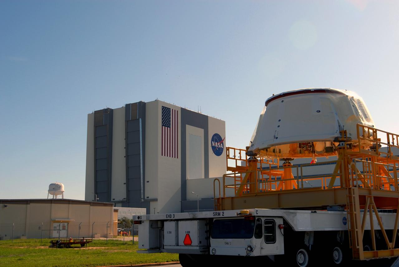 CAPE CANAVERAL, Fla. – The Ares I-X aft skirt moves past the Vehicle Assembly Building at NASA's Kennedy Space Center in Florida on its way to the Rotation, Processing and Surge Facility.  In the RPSF, it will be stacked with the aft motor to form the aft assembly.  The complete Ares I-X will be assembled in the Vehicle Assembly Building. The launch of Ares I-X is targeted for August 2009. Photo credit: NASA/Jim Grossmann