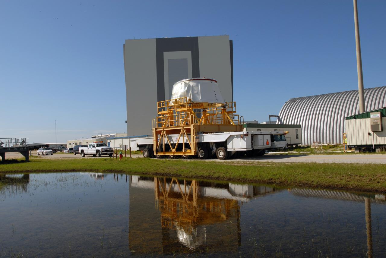 CAPE CANAVERAL, Fla. – The Ares I-X aft skirt moves past the Vehicle Assembly Building at NASA's Kennedy Space Center in Florida on its way to the Rotation, Processing and Surge Facility.  In the RPSF, it will be stacked with the aft motor to form the aft assembly.  The complete Ares I-X will be assembled in the Vehicle Assembly Building. The launch of Ares I-X is targeted for August 2009. Photo credit: NASA/Jim Grossmann
