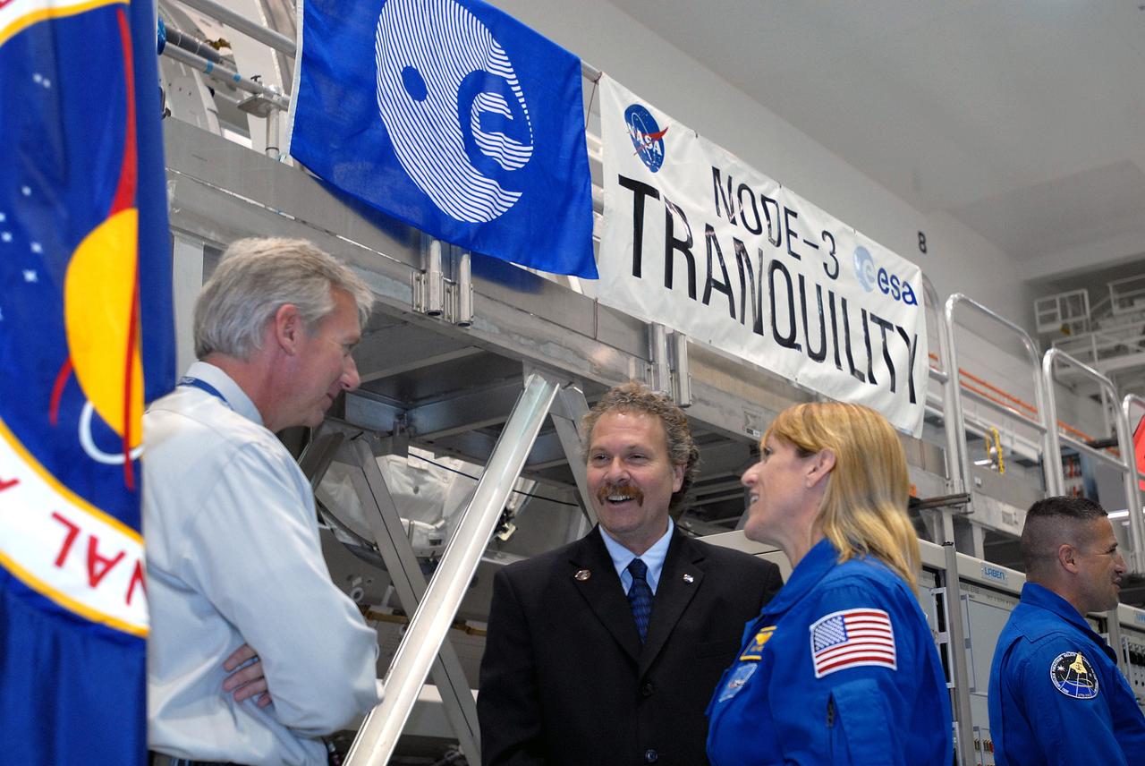 CAPE CANAVERAL, Fla. – – During a media event in the Space Station Processing Facility at NASA's Kennedy Space Center in Florida to showcase the newest section of the International Space Station, the Tranquility node, astronaut Kay Hire and Director of the ISS and Spacecraft Processing Directorate Russell Romanella (center) talk with Mark Jager, program manager, with Checkout Assembly and Payload Processing Services at The Boeing Company. At far right is astronaut George Zamka, who is commander for the STS-130 mission that will deliver Tranquility to the space station. Managers from NASA, the European Space Agency, Thales Alenia Space and Boeing -- the organizations involved in building and processing the module for flight -- were available for a question-and-answer session during the event. Tranquility is a pressurized module that will provide room for many of the station's life support systems. Photo credit: NASA/Jim Grossmann
