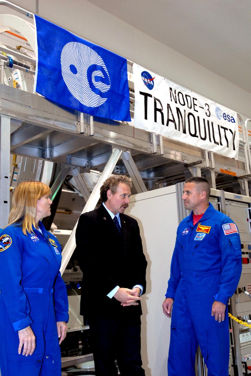 CAPE CANAVERAL, Fla. – – During a media event in the Space Station Processing Facility at NASA's Kennedy Space Center in Florida to showcase the newest section of the International Space Station, the Tranquility node, Director of the ISS and Spacecraft Processing Directorate Russell Romanella (center) talks with two of the astronauts who will deliver Tranquility to the space station on the STS-130 mission, Mission Specialist Kay Hire and Commander George Zamka. Managers from NASA, the European Space Agency, Thales Alenia Space and Boeing -- the organizations involved in building and processing the module for flight -- were available for a question-and-answer session during the event. Tranquility is a pressurized module that will provide room for many of the station's life support systems. Photo credit: NASA/Jim Grossmann