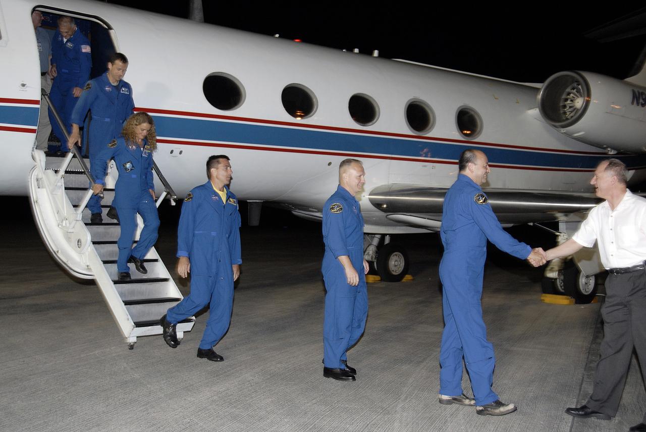 CAPE CANAVERAL, Fla. – Members of the STS-127 crew are greeted by STS-127 Launch Director Pete Nickolenko, at right, as they disembark from a Shuttle Training Aircraft at the Shuttle Landing Facility at NASA's Kennedy Space Center in Florida. From right to left are Commander Mark Polansky, Pilot Doug Hurley, and Mission Specialists Christopher Cassidy, Julie Payette of the Canadian Space Agency, Tom Marshburn and Dave Wolf. Polansky will be making his third shuttle flight. Hurley, Cassidy, and Marshburn will be making their first shuttle flights; Wolf, his fourth, and Payette, her second.  The crew arrived aboard the aircraft from Houston to prepare for launch on space shuttle Endeavour on June 13.  The STS-127 mission is the final of three flights dedicated to the assembly of the Japan Aerospace Exploration Agency's Kibo laboratory complex on the International Space Station.  Endeavour will deliver the Japanese Experiment Module's Exposed Facility, or JEM-EF, and the Experiment Logistics Module-Exposed Section, or ELM-ES, to the space station on STS-127.  Photo credit: NASA/Kim Shiflett