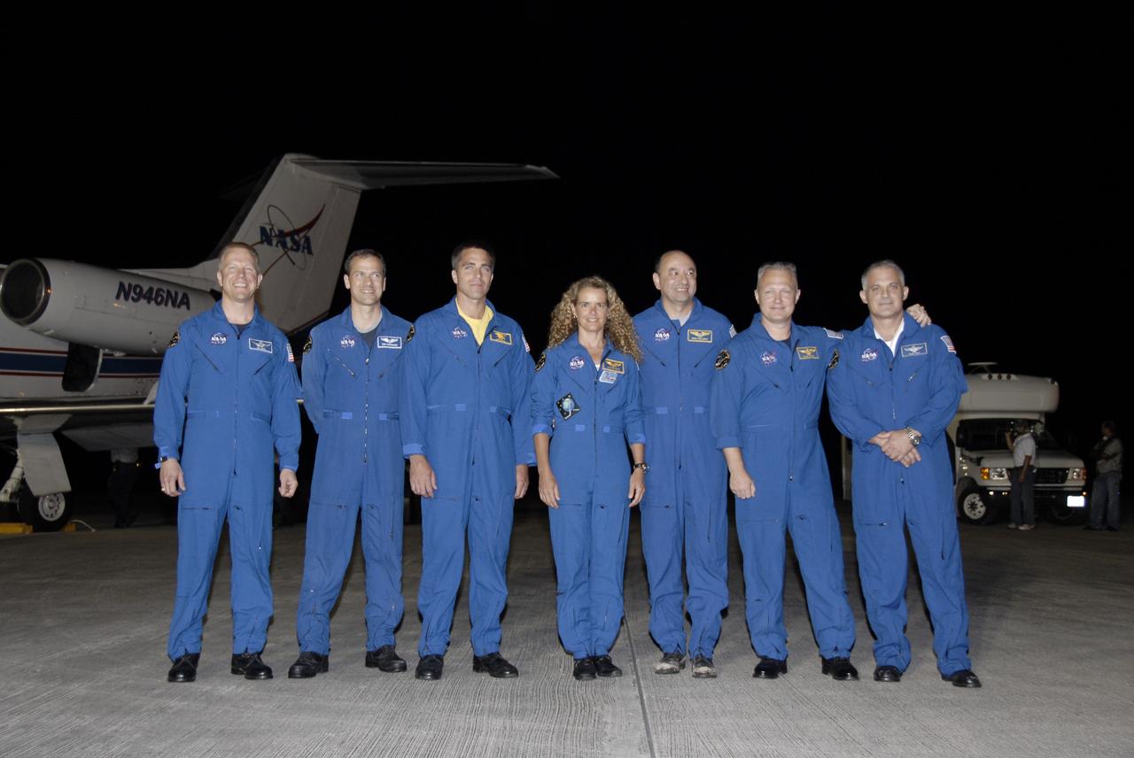 CAPE CANAVERAL, Fla. – The STS-127 crew poses for a group portrait following their arrival at the Shuttle Landing Facility at NASA's Kennedy Space Center in Florida. From left are Mission Specialists Tim Kopra, Tom Marshburn, Christopher Cassidy, and Julie Payette of the Canadian Space Agency; Commander Mark Polansky; Pilot Doug Hurley; and Mission Specialist Dave Wolf.  The crew arrived from Houston aboard the Shuttle Training Aircraft in the background to get ready for launch on space shuttle Endeavour on June 13.     The STS-127 mission is the final of three flights dedicated to the assembly of the Japan Aerospace Exploration Agency's Kibo laboratory complex on the International Space Station.  Endeavour will deliver the Japanese Experiment Module's Exposed Facility, or JEM-EF, and the Experiment Logistics Module-Exposed Section, or ELM-ES, to the space station on STS-127.  Photo credit: NASA/Kim Shiflett