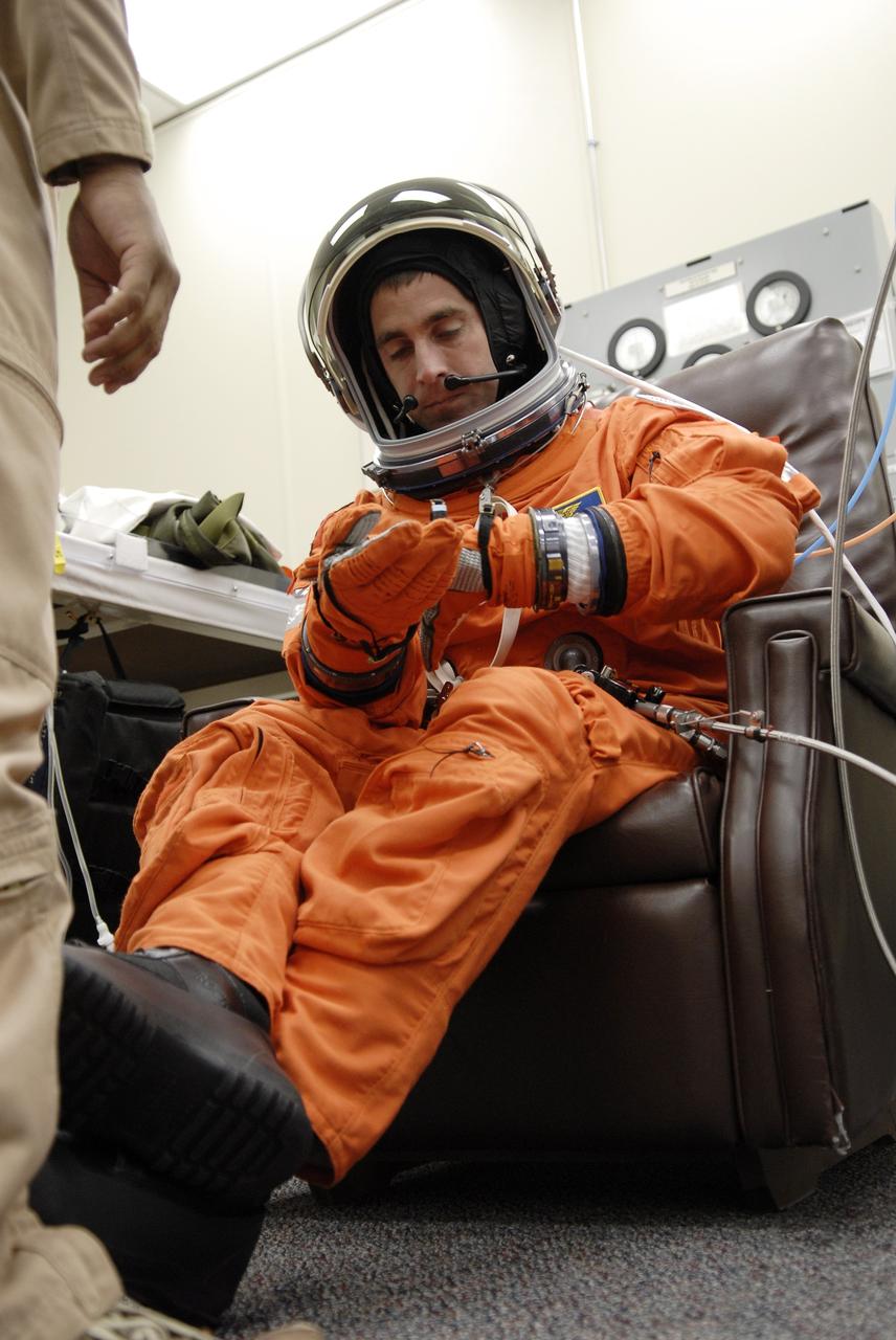 CAPE CANAVERAL, Fla. –  At NASA's Kennedy Space Center in Florida, STS-127 Mission Specialist Christopher Cassidy checks his gloves during fit-check of his launch-and-entry suit in preparation for space shuttle Endeavour's launch on June 13 to the International Space Station.  Cassidy will be making his first shuttle flight.  Endeavour will deliver the Japanese Experiment Module's Exposed Facility, or JEM-EF, and the Experiment Logistics Module-Exposed Section, or ELM-ES, on STS-127. The mission is the final of three flights dedicated to the assembly of the Japan Aerospace Exploration Agency's Kibo laboratory complex on the space station.   Photo credit: NASA/Kim Shiflett