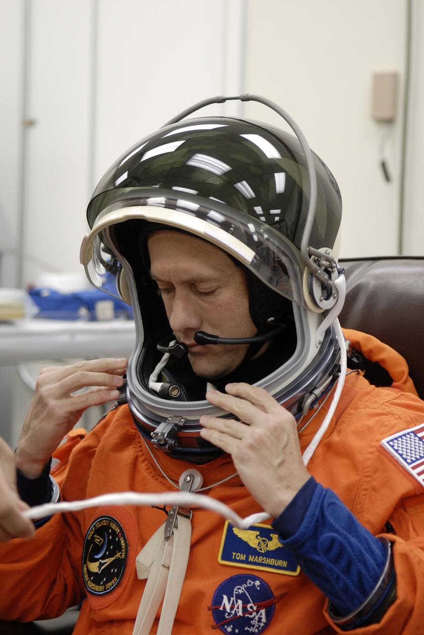CAPE CANAVERAL, Fla. –  At NASA's Kennedy Space Center in Florida, STS-127 Mission Specialist Tom Marshburn checks the fit of his helmet during fit-check of his launch-and-entry suit in preparation for space shuttle Endeavour's launch on June 13 to the International Space Station.  Marshburn will be making his first shuttle flight.  Endeavour will deliver the Japanese Experiment Module's Exposed Facility, or JEM-EF, and the Experiment Logistics Module-Exposed Section, or ELM-ES, on STS-127. The mission is the final of three flights dedicated to the assembly of the Japan Aerospace Exploration Agency's Kibo laboratory complex on the space station.   Photo credit: NASA/Kim Shiflett