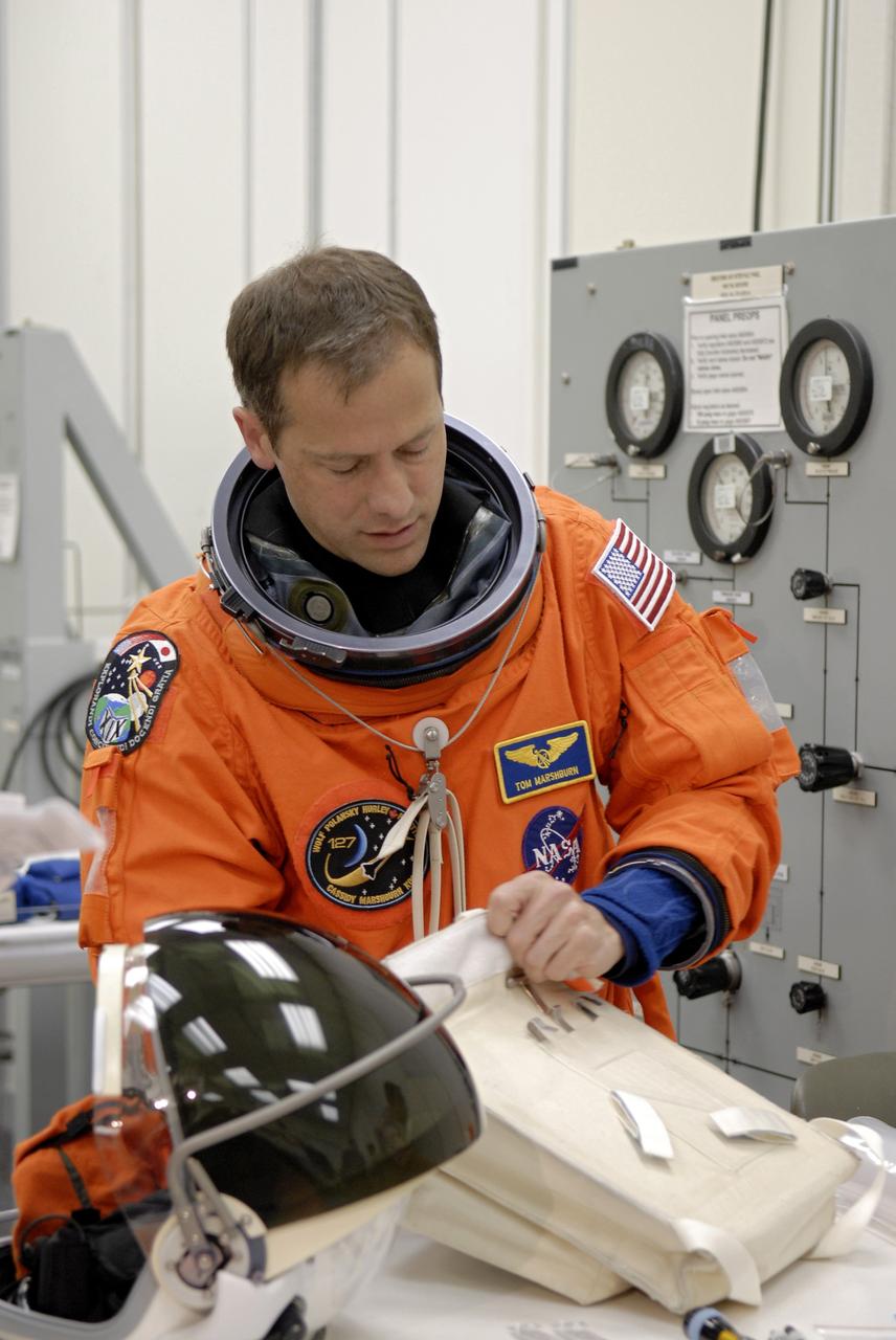 CAPE CANAVERAL, Fla. –  At NASA's Kennedy Space Center in Florida, STS-127 Mission Specialist Tom Marshburn checks equipment as part of pre-pack and fit check in preparation for space shuttle Endeavour's launch on June 13 to the International Space Station.  Marshburn will be making his first shuttle flight. Endeavour will deliver the Japanese Experiment Module's Exposed Facility, or JEM-EF, and the Experiment Logistics Module-Exposed Section, or ELM-ES, on STS-127. The mission is the final of three flights dedicated to the assembly of the Japan Aerospace Exploration Agency's Kibo laboratory complex on the space station.   Photo credit: NASA/Kim Shiflett