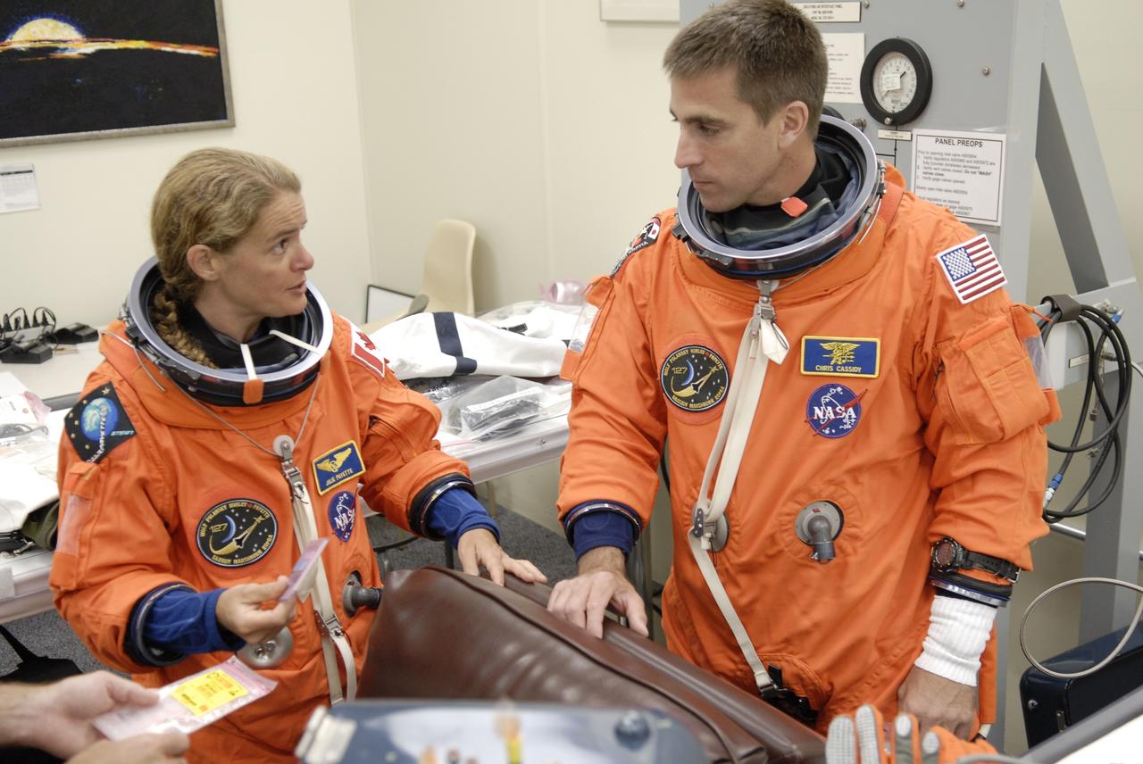 CAPE CANAVERAL, Fla. –  At NASA's Kennedy Space Center in Florida, STS-127 Mission Specialists Julie Payette and Christopher Cassidy check equipment as part of pre-pack and fit check in preparation for space shuttle Endeavour's launch on June 13 to the International Space Station.  Payette, who is with the Canadian Space Agency, will be making her second shuttle flight, and Cassidy his first.  Endeavour will deliver the Japanese Experiment Module's Exposed Facility, or JEM-EF, and the Experiment Logistics Module-Exposed Section, or ELM-ES, on STS-127. The mission is the final of three flights dedicated to the assembly of the Japan Aerospace Exploration Agency's Kibo laboratory complex on the space station.   Photo credit: NASA/Kim Shiflett