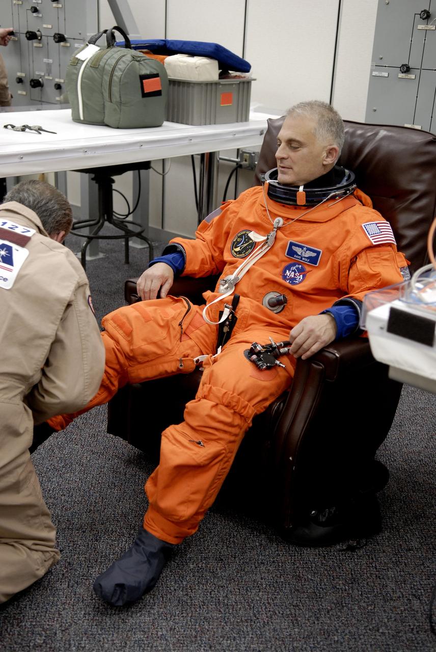 CAPE CANAVERAL, Fla. –  At NASA's Kennedy Space Center in Florida, STS-127 Mission Specialist Dave Wolf checks the fit of his boot during fit-check of his launch-and-entry suit in preparation for space shuttle Endeavour's launch on June 13 to the International Space Station.  Wolf will be making his fourth shuttle flight.   Endeavour will deliver the Japanese Experiment Module's Exposed Facility, or JEM-EF, and the Experiment Logistics Module-Exposed Section, or ELM-ES, on STS-127. The mission is the final of three flights dedicated to the assembly of the Japan Aerospace Exploration Agency's Kibo laboratory complex on the space station.   Photo credit: NASA/Kim Shiflett
