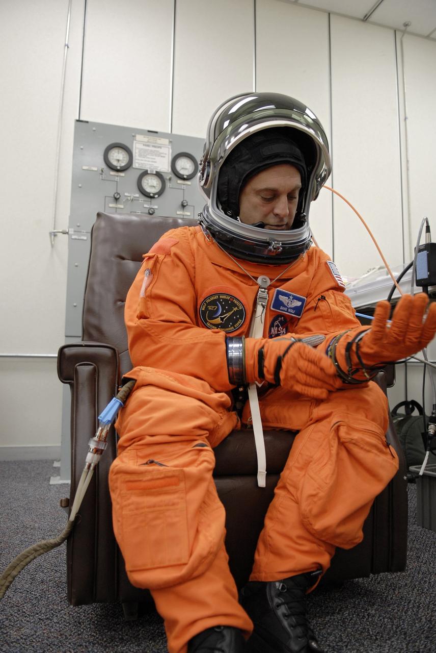 CAPE CANAVERAL, Fla. –  At NASA's Kennedy Space Center in Florida, STS-127 Mission Specialist Dave Wolf checks the fit of his glove during fit-check of his launch-and-entry suit in preparation for space shuttle Endeavour's launch on June 13 to the International Space Station.  Wolf will be making his fourth shuttle flight.  Endeavour will deliver the Japanese Experiment Module's Exposed Facility, or JEM-EF, and the Experiment Logistics Module-Exposed Section, or ELM-ES, on STS-127. The mission is the final of three flights dedicated to the assembly of the Japan Aerospace Exploration Agency's Kibo laboratory complex on the space station.   Photo credit: NASA/Kim Shiflett