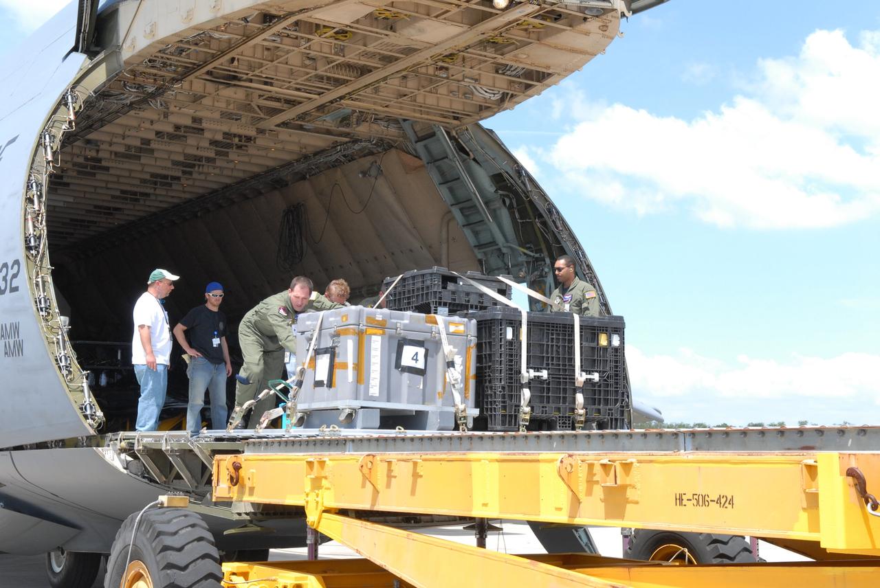 CAPE CANAVERAL, Fla. –  At NASA Kennedy Space Center's Shuttle Landing Facility, workers move STSS Demonstrator SV-2 spacecraft equipment out of the cargo hold of the U.S. Air Force C-17 aircraft.  The spacecraft will be transferred to the Astrotech payload processing facility in Titusville, Fla. The spacecraft is a midcourse tracking technology demonstrator, part of an evolving ballistic missile defense system. STSS is capable of tracking objects after boost phase and provides trajectory information to other sensors. It will be launched by NASA for the Missile Defense Agency in late summer.  Photo credit: NASA/Jack Pfaller  (Approved for Public Release 09-MDA-4616 [27 May 09])