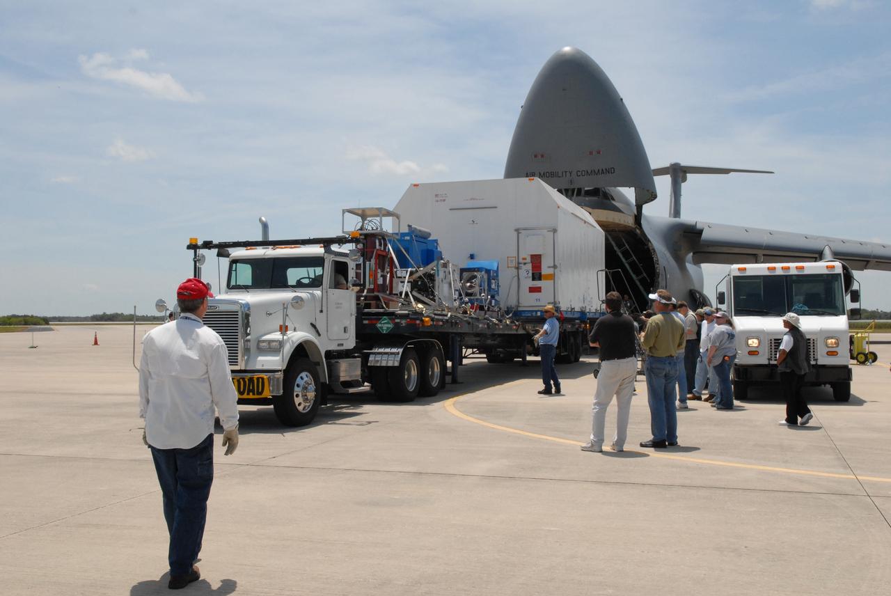 CAPE CANAVERAL, Fla. –  At NASA Kennedy Space Center's Shuttle Landing Facility,  the shipping container with the STSS Demonstrator SV-2spacecraft is secured on a trailer for transfer to the Astrotech payload processing facility in Titusville, Fla.  The spacecraft is a midcourse tracking technology demonstrator, part of an evolving ballistic missile defense system. STSS is capable of tracking objects after boost phase and provides trajectory information to other sensors. It will be launched by NASA for the Missile Defense Agency in late summer.  Photo credit: NASA/Jack Pfaller  (Approved for Public Release 09-MDA-4616 [27 May 09])