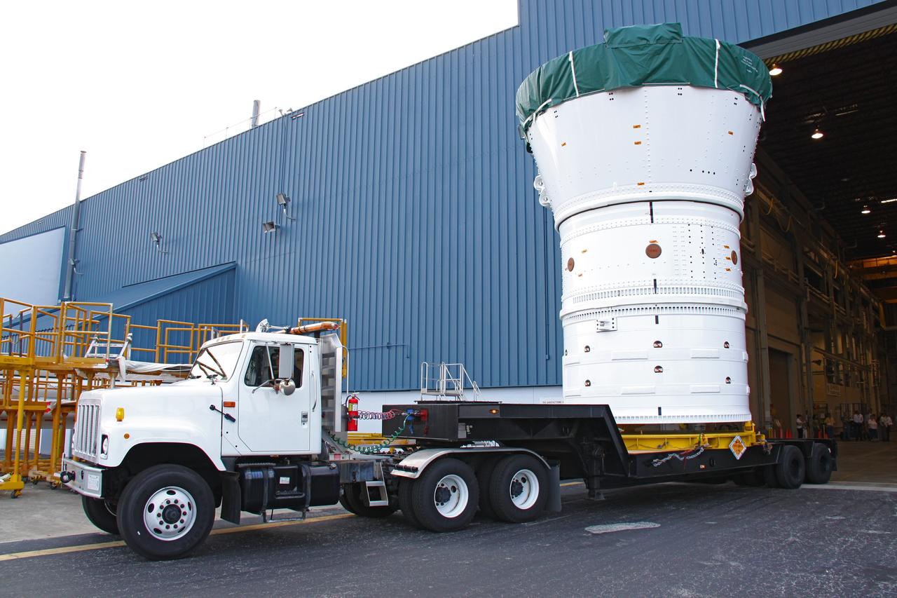 CAPE CANAVERAL, Fla. –  At NASA's Kennedy Space Center in Florida, the Ares I-X forward assembly (comprising the frustum, forward skirt extension and forward skirt) moves out of the Assembly and Refurbishment Facility.  It is being transferred to the Vehicle Assembly Building's High Bay 4 for processing and stacking to the upper stage. Ares I-X is the flight test for the Ares I which will provide NASA an early opportunity to test and prove hardware, facilities and ground operations associated with Ares I, which is part of the Constellation Program to return men to the moon and beyond. Launch of the Ares I-X flight test is targeted for August 2009.   Photo credit: NASA/Jack Pfaller