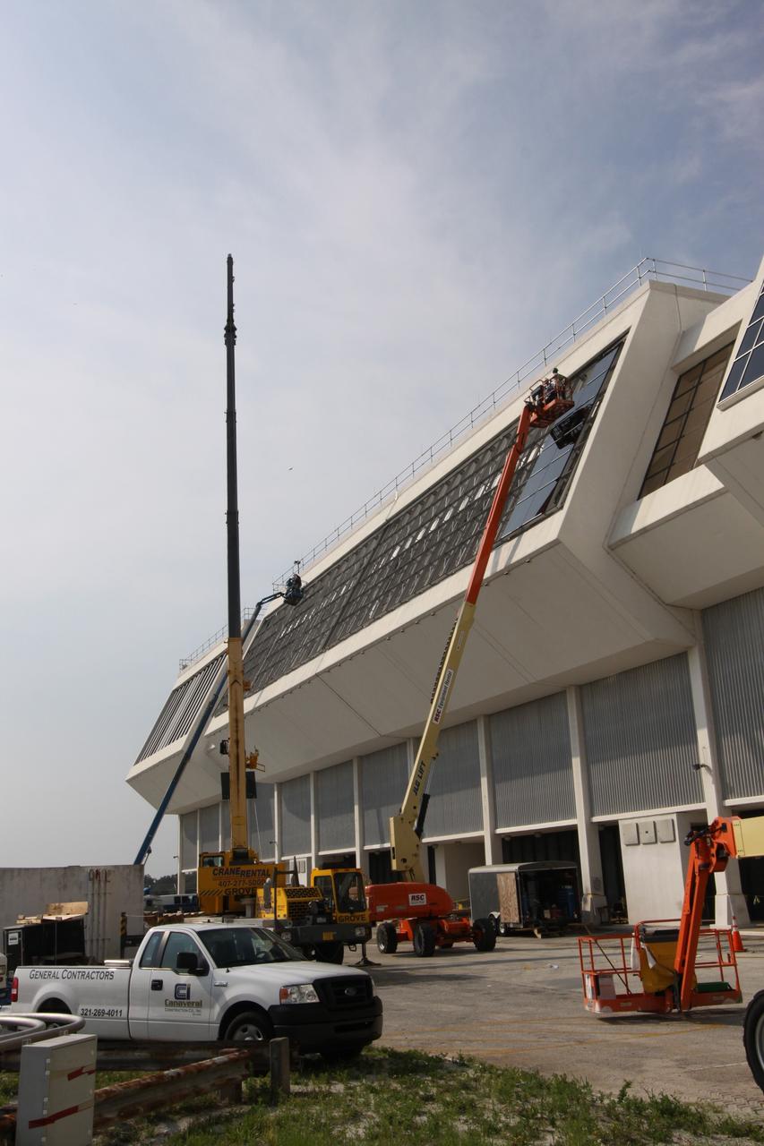CAPE CANAVERAL, Fla. –  Work continues on removing the louvers and replacing the windows on the Firing Room windows in the Launch Control Center at NASA's Kennedy Space Center in Florida.  New, hurricane-rated window systems for the four Firing Rooms and the vestibule areas between Firing Rooms 1 & 2 and Firing Rooms 3 & 4 are being installed. In order to avoid operational impacts the new windows are being installed on the outside of the existing windows, enclosing the space formerly occupied by the louvers.  The old windows will remain in place until the new windows are completely installed and leak tested. This approach will continue to keep the firing rooms from being exposed to the elements.   Photo credit: NASA/Jack Pfaller