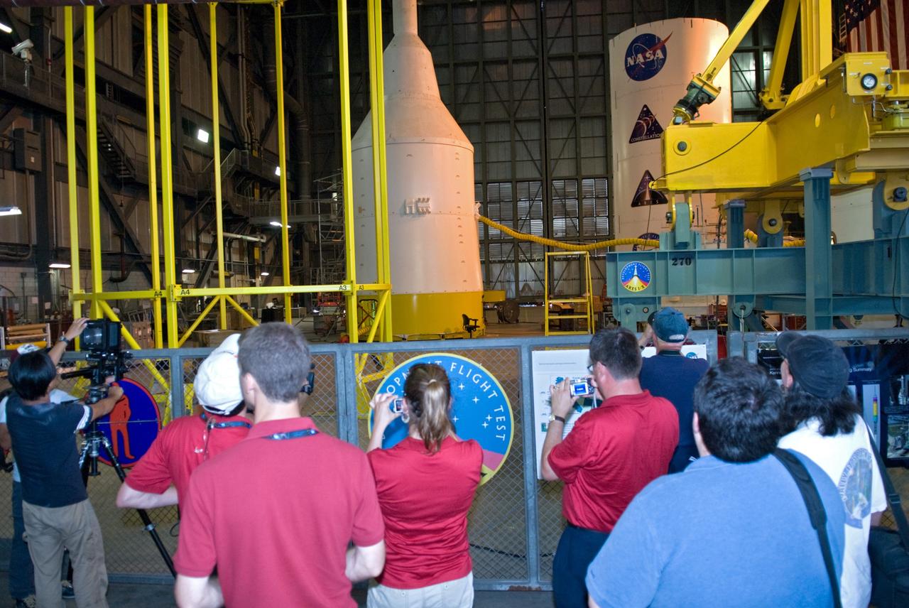 CAPE CANAVERAL, Fla. –  In the Vehicle Assembly Building at NASA's Kennedy Space Center in Florida, media get a close look at various segments for the Ares I-X rocket being assembled in High Bay 4.  In front at left is the yellow crane known as the "birdcage" that is used to lift the crew module-launch abort system. Ares I-X is the test vehicle for the Ares I, which is part of the Constellation Program to return men to the moon and beyond. Ares I-X is targeted for launch in August 2009.  Photo credit: NASA/Kim Shiflett