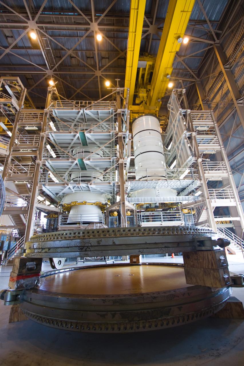 CAPE CANAVERAL, Fla. –  In the Rotation, Processing, and Surge Facility at NASA's Kennedy Space Center in Florida, the Ares I-X aft skirt is mated to the aft segment (at right).  At left is a stack of segments of a solid rocket booster for a shuttle.  The launch of Ares I-X is targeted for August 2009.  Photo credit: NASA/Jack Pfaller