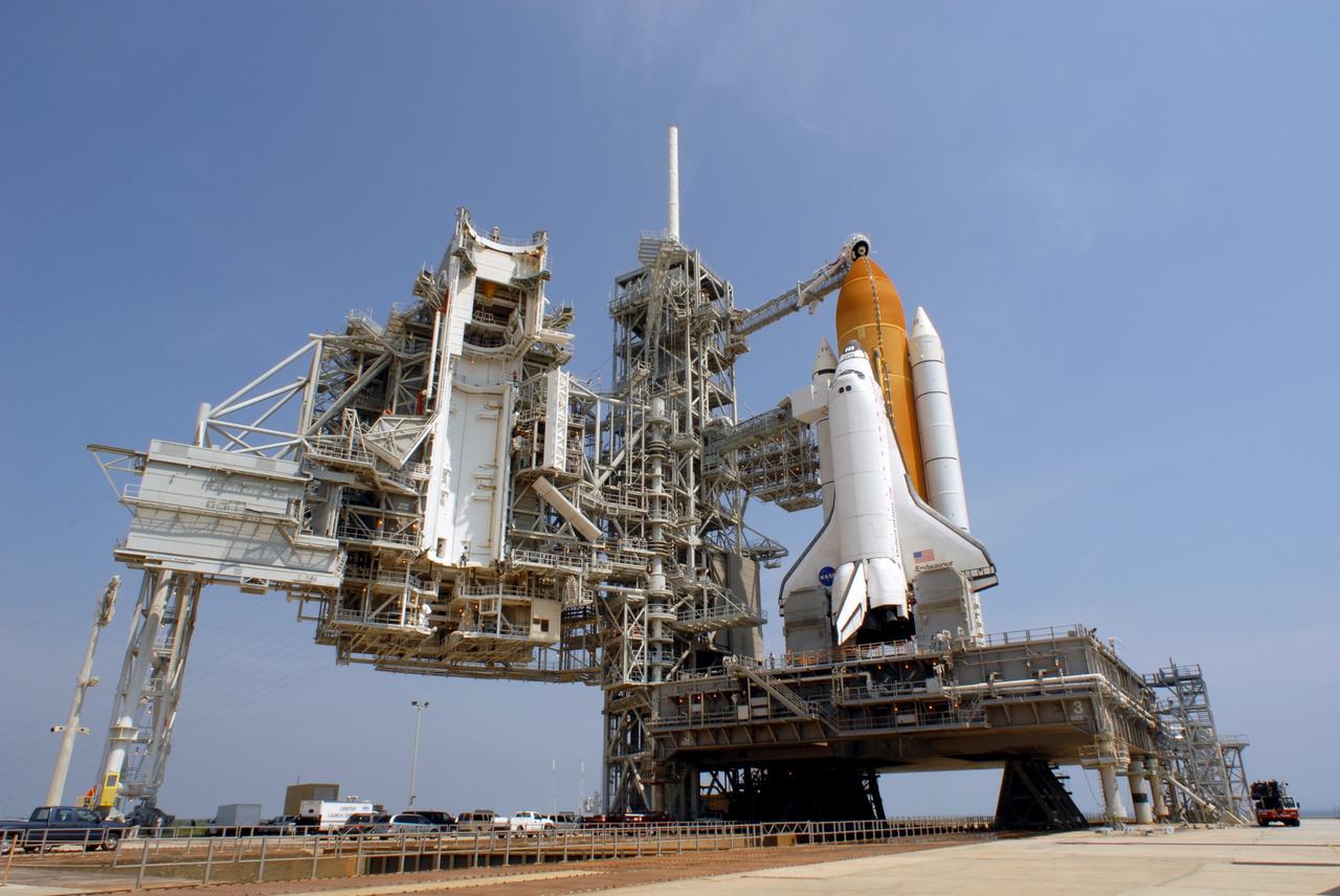 CAPE CANAVERAL, Fla. – On Launch Pad 39A at NASA's Kennedy Space Center in Florida, the oxygen vent hood, called the "beanie cap," is positioned above the external fuel tank of space shuttle Endeavour following the rollback of the rotating service structure, or RSS, at left. The beanie cap is designed to vent gaseous oxygen vapors away from the shuttle. The rollback is preparation for Endeavour's liftoff June 13 on the STS-127 mission with a crew of seven. First motion was at 10:39 a.m. EDT and completed at 11:18 a.m. The rotating structure provides protected access to the shuttle for changeout and servicing of payloads at the pad. It is supported by a rotating bridge that pivots on a vertical axis on the west side of the pad's flame trench. After the RSS is rolled back, the orbiter is ready for fuel cell activation and external tank cryogenic propellant loading operations. The launch will be Endeavour's 23rd flight. The shuttle will carry the Japanese Experiment Module's Exposed Facility, or JEM-EF, and the Experiment Logistics Module-Exposed Section, or ELM-ES, on STS-127. The mission is the final of three flights dedicated to the assembly of the Japan Aerospace Exploration Agency's Kibo laboratory complex on the space station. Endeavour's launch is scheduled for June 13 at 7:17 a.m. EDT. Photo credit: NASA/Jim Grossmann