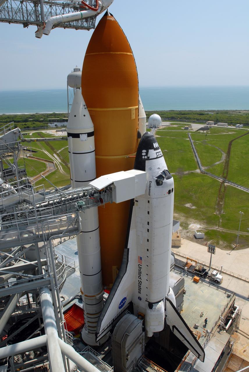CAPE CANAVERAL, Fla. – On Launch Pad 39A at NASA's Kennedy Space Center in Florida, space shuttle Endeavour is revealed after the rollback of the rotating service structure, or RSS. On the left of Endeavour is the White Room, at the end of the orbiter access arm. The White Room provides entry into the shuttle for the astronauts. The rollback is preparation for Endeavour's liftoff June 13 on the STS-127 mission with a crew of seven. First motion was at 10:39 a.m. EDT and completed at 11:18 a.m. The rotating structure provides protected access to the shuttle for changeout and servicing of payloads at the pad. It is supported by a rotating bridge that pivots on a vertical axis on the west side of the pad's flame trench. After the RSS is rolled back, the orbiter is ready for fuel cell activation and external tank cryogenic propellant loading operations. The launch will be Endeavour's 23rd flight. The shuttle will carry the Japanese Experiment Module's Exposed Facility, or JEM-EF, and the Experiment Logistics Module-Exposed Section, or ELM-ES, on STS-127. The mission is the final of three flights dedicated to the assembly of the Japan Aerospace Exploration Agency's Kibo laboratory complex on the space station. Endeavour's launch is scheduled for June 13 at 7:17 a.m. EDT. Photo credit: NASA/Jim Grossmann