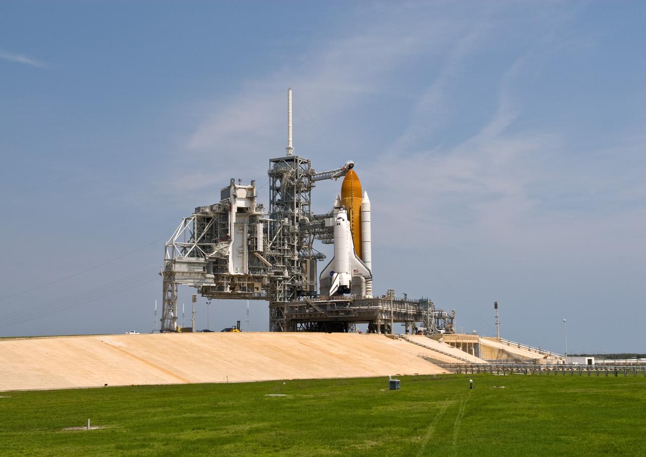 CAPE CANAVERAL, Fla. – The open rotating service structure, or RSS (left), on Launch Pad 39A at NASA's Kennedy Space Center in Florida reveals space shuttle Endeavour poised for launch. The RSS was rotated to its open position in preparation for Endeavour's liftoff June 13 on the STS-127 mission with a crew of seven. First motion was at 10:39 a.m. EDT and completed at 11:18 a.m. The rotating structure provides protected access to the shuttle for changeout and servicing of payloads at the pad. It is supported by a rotating bridge that pivots on a vertical axis on the west side of the pad's flame trench. After the RSS is rolled back, the orbiter is ready for fuel cell activation and external tank cryogenic propellant loading operations. The launch will be Endeavour's 23rd flight. The shuttle will carry the Japanese Experiment Module's Exposed Facility, or JEM-EF, and the Experiment Logistics Module-Exposed Section, or ELM-ES, on STS-127. The mission is the final of three flights dedicated to the assembly of the Japan Aerospace Exploration Agency's Kibo laboratory complex on the space station. Endeavour's launch is scheduled for June 13 at 7:17 a.m. EDT. Photo credit: NASA/Jim Grossmann