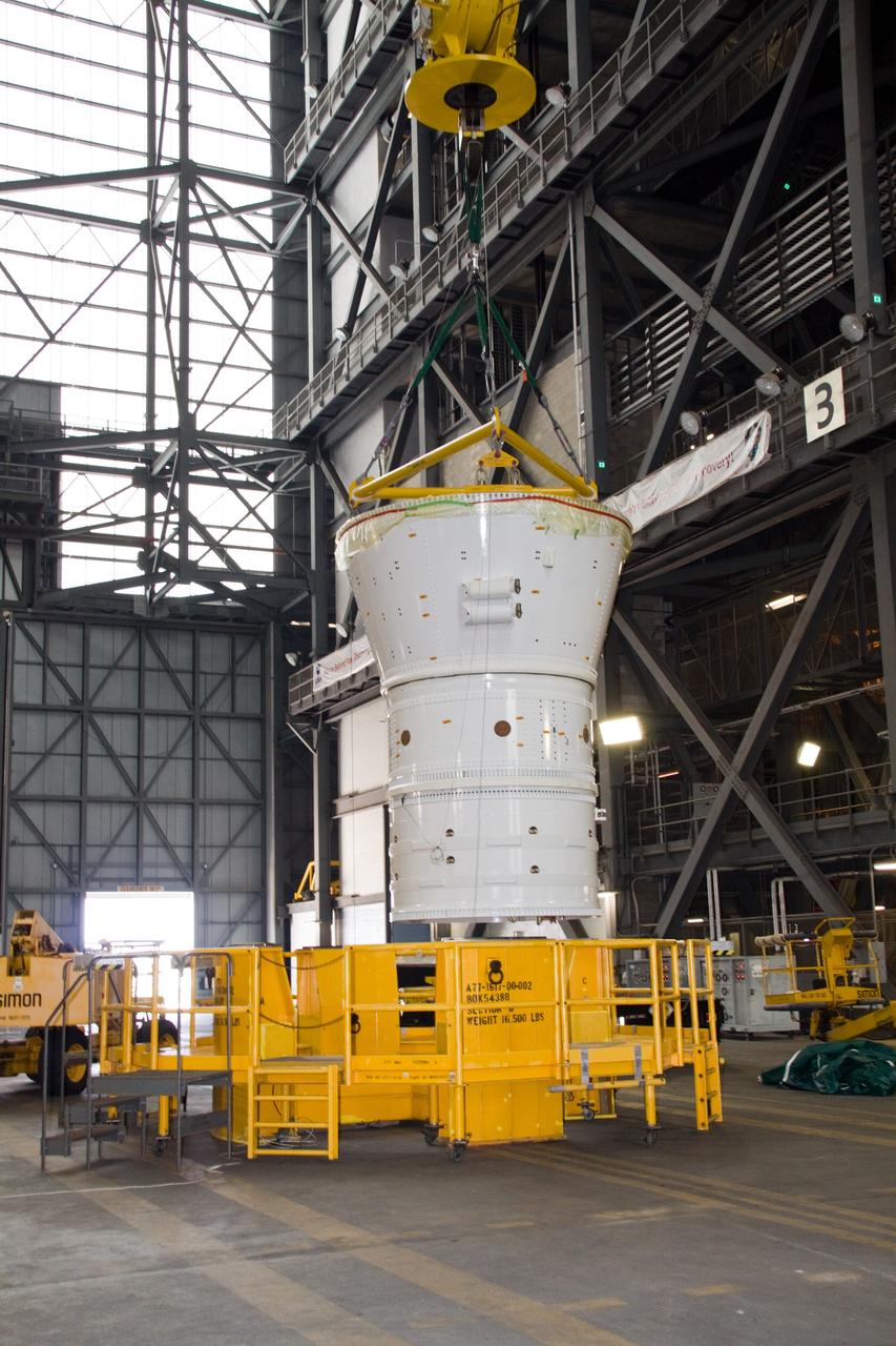 CAPE CANAVERAL, Fla. – In the Vehicle Assembly Building's transfer aisle at NASA's Kennedy Space Center in Florida, a crane lifts the Ares I-X forward assembly toward a stand in preparation for being moved into High Bay 4. Ares I-X is the flight test vehicle for the Ares I, a component of the Constellation Program. Ares I is the essential core of a safe, reliable, cost-effective space transportation system that eventually will carry crewed missions back to the moon, on to Mars and out into the solar system. The launch of the Ares I-X flight test is targeted for August 2009. Photo credit: NASA/Jack Pfaller