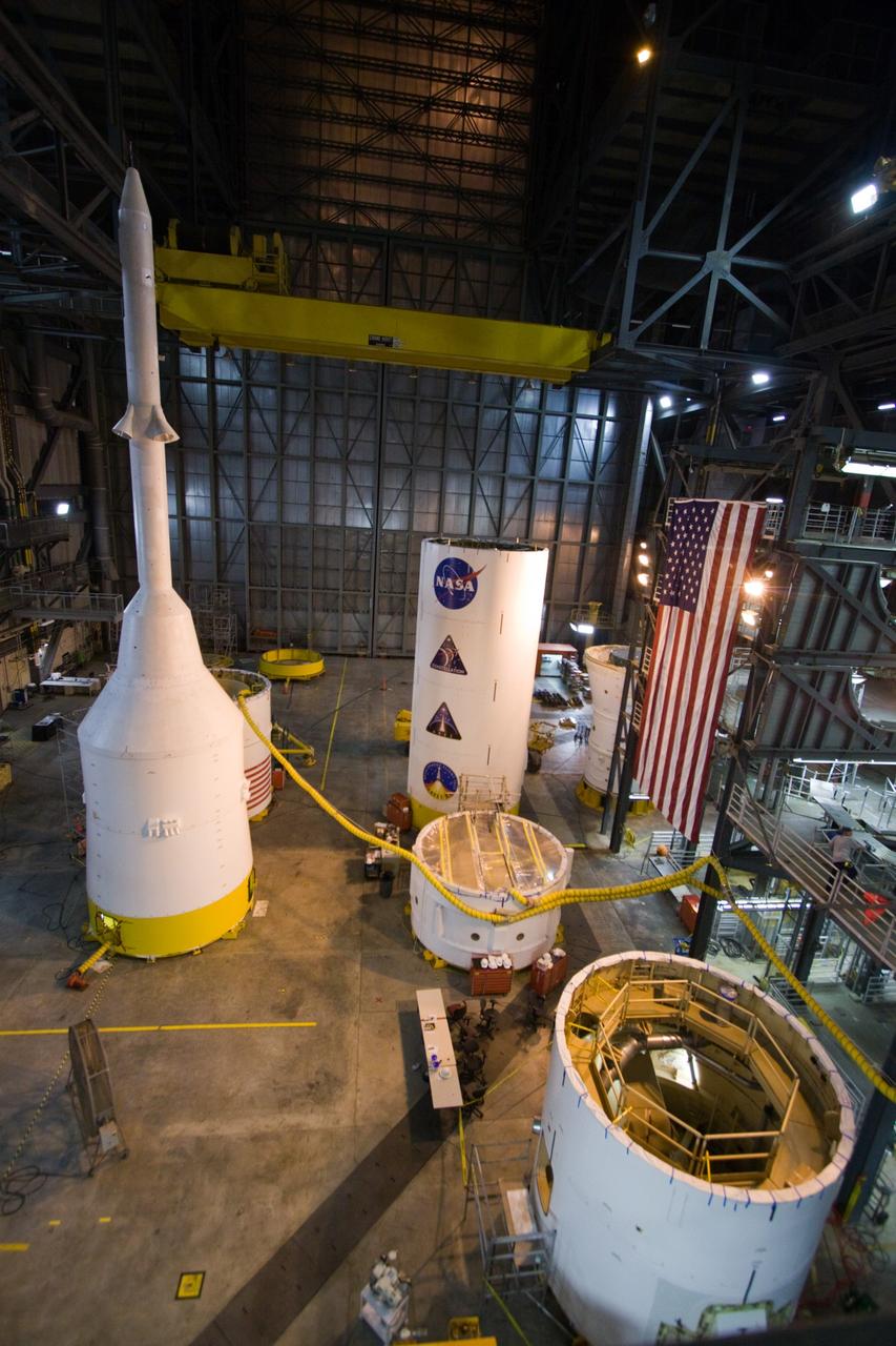 CAPE CANAVERAL, Fla. – Ares I-X segments and stacks are filling the floor of the Vehicle Assembly Building's High Bay 4 at NASA's Kennedy Space Center in Florida. At left in the background is the crew module-launch abort system, or CM-LAS, and simulator service module-service adapter stack. Not seen is the forward assembly that has joined the other segments. Ares I-X is the flight test vehicle for the Ares I, a component of the Constellation Program. Ares I is the essential core of a safe, reliable, cost-effective space transportation system that eventually will carry crewed missions back to the moon, on to Mars and out into the solar system. The launch of the Ares I-X flight test is targeted for August 2009. Photo credit: NASA/Jack Pfaller