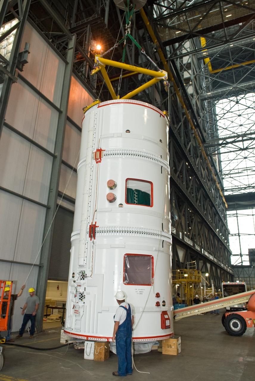 CAPE CANAVERAL, Fla. –  In the transfer aisle of the Vehicle Assembly Building at NASA's Kennedy Space Center in Florida, a crane is attached to the fifth segment simulator assembly for the Ares I-X.  The crane will lift and move the segment assembly into High Bay 4.  Ares I-X is the flight test vehicle for the Ares I, a component of the Constellation Program. Ares I is the essential core of a safe, reliable, cost-effective space transportation system that eventually will carry crewed missions back to the moon, on to Mars and out into the solar system. The launch of the Ares I-X flight test is targeted for August 2009. Photo credit: NASA/Jim Grossmann