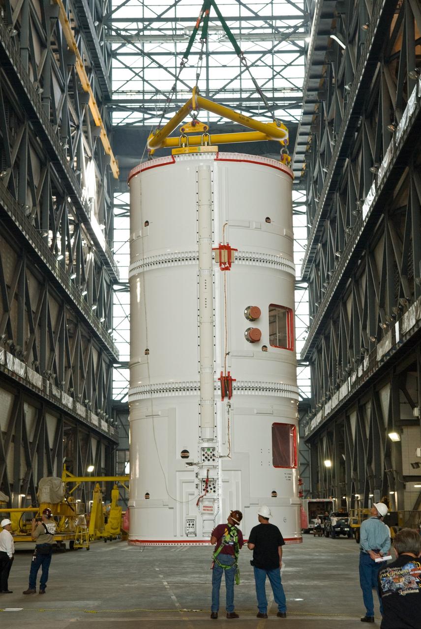 CAPE CANAVERAL, Fla. –  In the transfer aisle of the Vehicle Assembly Building at NASA's Kennedy Space Center in Florida, a crane lifts the fifth segment simulator assembly for the Ares I-X to move it into High Bay 4.  Ares I-X is the flight test vehicle for the Ares I, a component of the Constellation Program. Ares I is the essential core of a safe, reliable, cost-effective space transportation system that eventually will carry crewed missions back to the moon, on to Mars and out into the solar system. The launch of the Ares I-X flight test is targeted for August 2009. Photo credit: NASA/Jim Grossmann