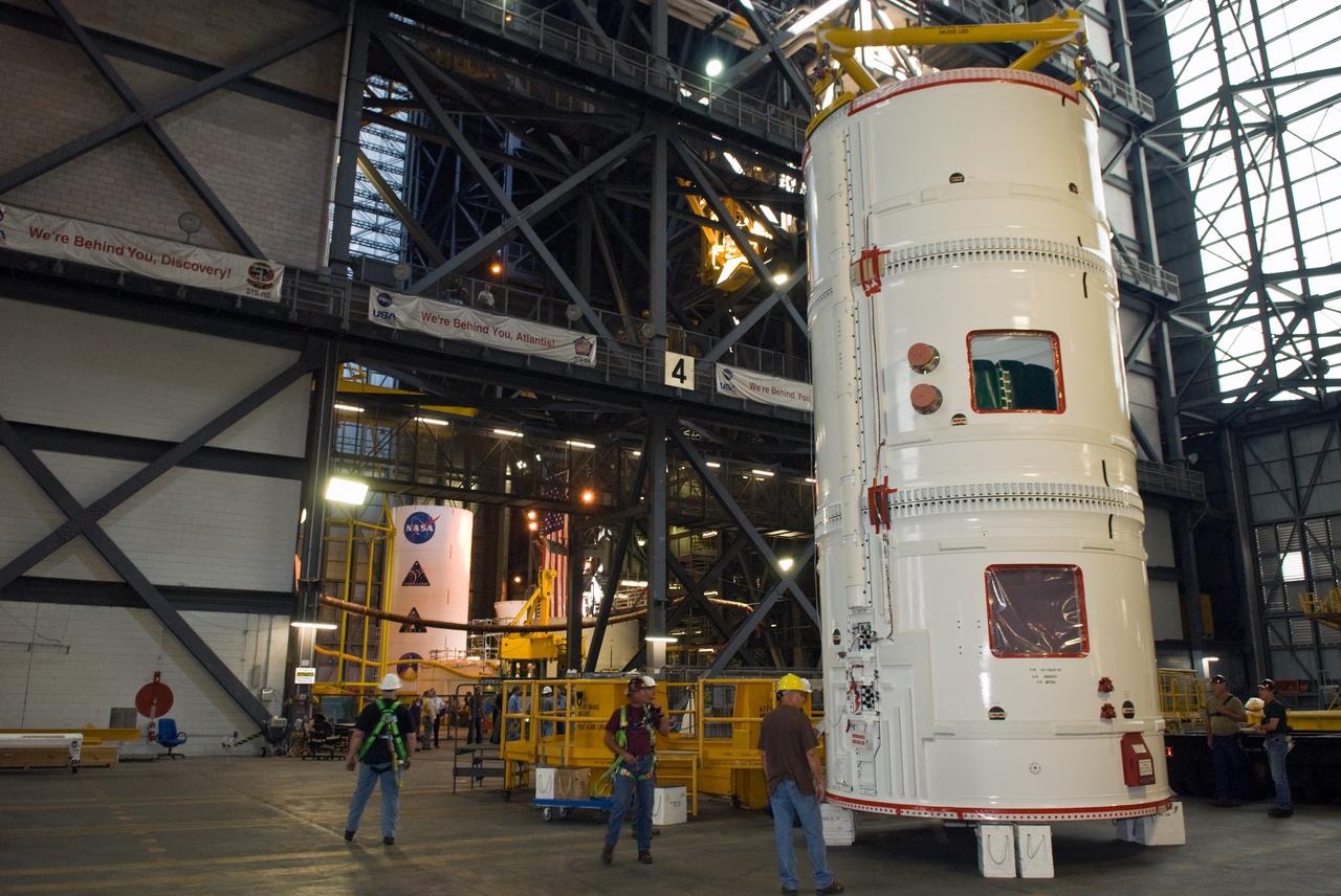 CAPE CANAVERAL, Fla. –  The fifth segment simulator assembly for the Ares I-X is moved onto a stand in the Vehicle Assembly Building near High Bay 4 at NASA's Kennedy Space Center in Florida.  Ares I-X is the flight test vehicle for the Ares I, a component of the Constellation Program. Ares I is the essential core of a safe, reliable, cost-effective space transportation system that eventually will carry crewed missions back to the moon, on to Mars and out into the solar system. The launch of the Ares I-X flight test is targeted for August 2009. Photo credit: NASA/Jim Grossmann