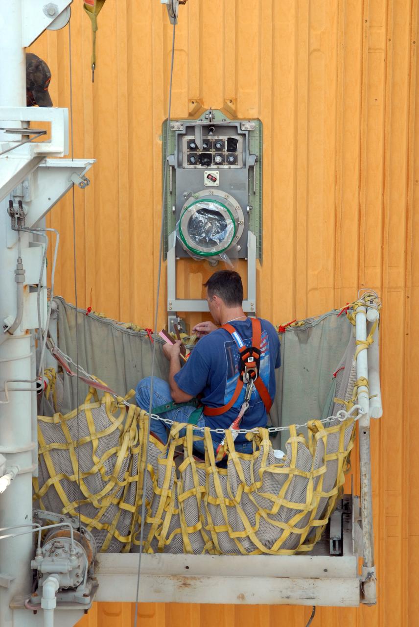 CAPE CANAVERAL, Fla. – On Launch Pad 39A at NASA's Kennedy Space Center in Florida, a worker prepares to remove the 7-inch quick disconnect and flight seal from the Ground Umbilical Carrier Plate, or GUCP, on space shuttle Endeavour's external fuel tank. Teams are removing the hardware to change out seals in the internal connection points. A leak of hydrogen at the location during tanking June 12 for the STS-127 mission caused the mission to be scrubbed at 12:26 a.m. June 13. The GUCP is the overboard vent to the pad and the flare stack where the vented hydrogen is burned off. Endeavour is scheduled to launch on its STS-127 mission on June 17 at 5:40 a.m. EDT. Photo credit: NASA/Tim Jacobs