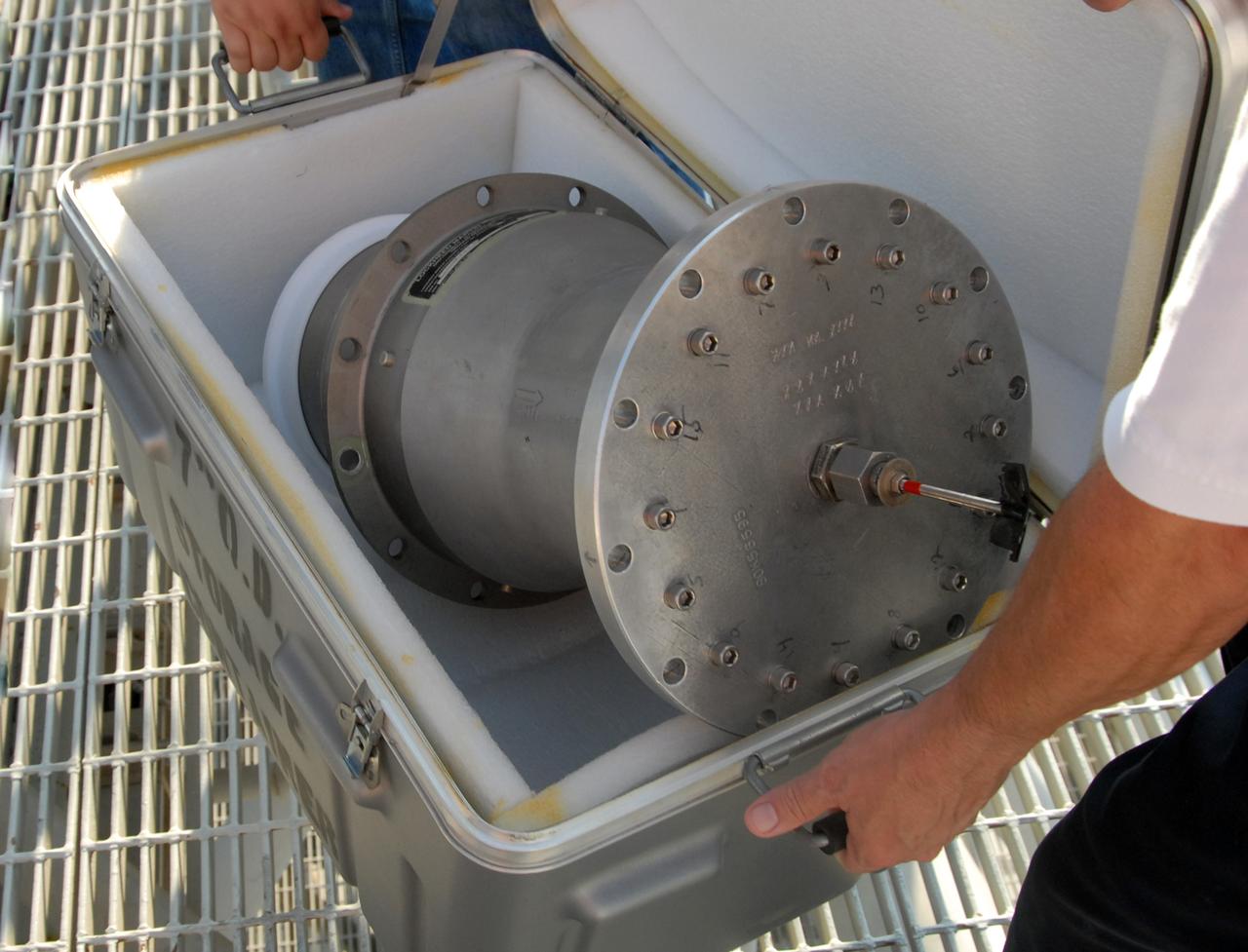 CAPE CANAVERAL, Fla. – On Launch Pad 39A at NASA's Kennedy Space Center in Florida, a worker has removed the 7-inch quick disconnect from the Ground Umbilical Carrier Plate, or GUCP, on space shuttle Endeavour's external fuel tank. Teams are removing the hardware to change out seals in the internal connection points. A leak of hydrogen at the location during tanking June 12 for the STS-127 mission caused the mission to be scrubbed at 12:26 a.m. June 13. The GUCP is the overboard vent to the pad and the flare stack where the vented hydrogen is burned off. Endeavour is scheduled to launch on its STS-127 mission on June 17 at 5:40 a.m. EDT. Photo credit: NASA/Tim Jacobs