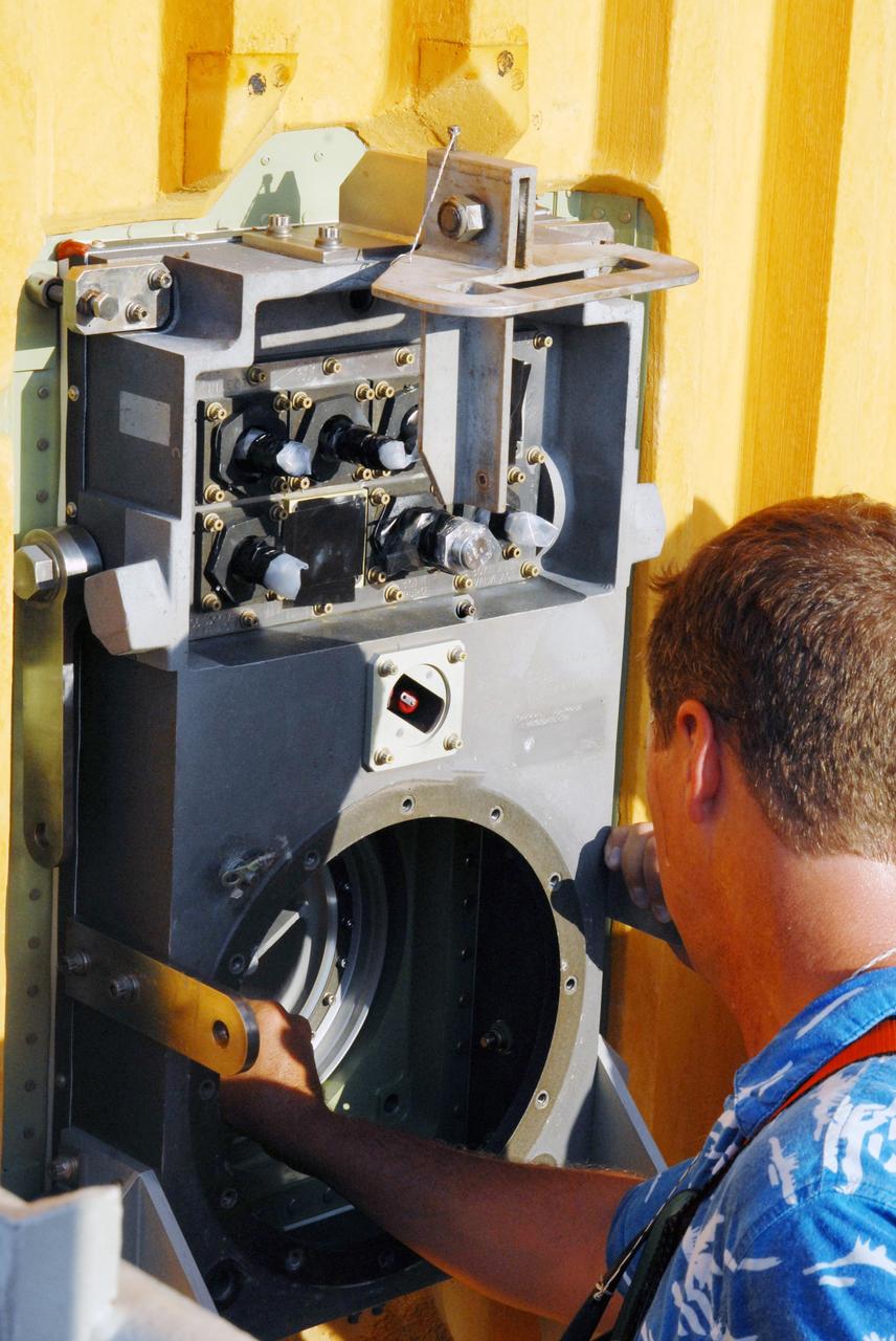 CAPE CANAVERAL, Fla. – On Launch Pad 39A at NASA's Kennedy Space Center in Florida, a worker checks the area on the Ground Umbilical Carrier Plate, or GUCP, where the 7-inch quick disconnect was removed. A leak of hydrogen at the location during tanking June 12 for the STS-127 mission caused the mission to be scrubbed at 12:26 a.m. June 13. The GUCP is the overboard vent to the pad and the flare stack where the vented hydrogen is burned off. Endeavour is scheduled to launch on its STS-127 mission on June 17 at 5:40 a.m. EDT. Photo credit: NASA/Tim Jacobs