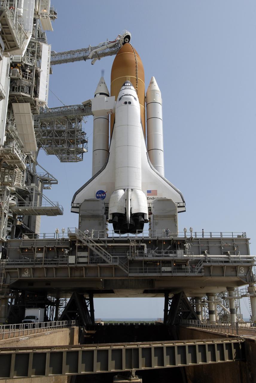CAPE CANAVERAL, Fla. –  After rollback of the rotating service structure, or RSS, on Launch Pad 39A at NASA's Kennedy Space Center in Florida, space shuttle Endeavour is revealed.  The shuttle sits on the mobile launcher platform, which straddles the flame trench below.  First motion of the RSS was at 10:15 a.m. EDT. The rollback is in preparation for Endeavour's liftoff on the STS-127 mission with a crew of seven. Above the external tank is the "beanie cap," the oxygen vent hood that is designed to vent gaseous oxygen vapors away from the shuttle.   This is the second launch attempt for Endeavour after the June 13 launch was scrubbed due to a hydrogen leak at the Ground Umbilical Carrier Plate during tanking June 12.  The launch will be Endeavour's 23rd flight. The shuttle will carry the Japanese Experiment Module's Exposed Facility, or JEM-EF, and the Experiment Logistics Module-Exposed Section, or ELM-ES, on STS-127. The mission is the final of three flights dedicated to the assembly of the Japan Aerospace Exploration Agency's Kibo laboratory complex on the space station. Endeavour's launch is scheduled for June 17 at 5:40 a.m. EDT.  Photo credit: NASA/Kim Shiflett