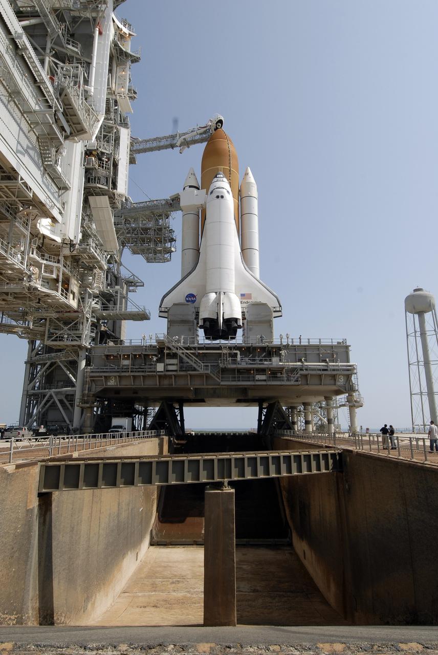 CAPE CANAVERAL, Fla. –  After rollback of the rotating service structure, or RSS, on Launch Pad 39A at NASA's Kennedy Space Center in Florida, space shuttle Endeavour is revealed.  The shuttle sits on the mobile launcher platform, which straddles the flame trench below.  First motion of the RSS was at 10:15 a.m. EDT. The rollback is in preparation for Endeavour's liftoff on the STS-127 mission with a crew of seven. Above the external tank is the "beanie cap," the oxygen vent hood that is designed to vent gaseous oxygen vapors away from the shuttle. This is the second launch attempt for Endeavour after the June 13 launch was scrubbed due to a hydrogen leak at the Ground Umbilical Carrier Plate during tanking June 12.  The launch will be Endeavour's 23rd flight. The shuttle will carry the Japanese Experiment Module's Exposed Facility, or JEM-EF, and the Experiment Logistics Module-Exposed Section, or ELM-ES, on STS-127. The mission is the final of three flights dedicated to the assembly of the Japan Aerospace Exploration Agency's Kibo laboratory complex on the space station. Endeavour's launch is scheduled for June 17 at 5:40 a.m. EDT.  Photo credit: NASA/Kim Shiflett