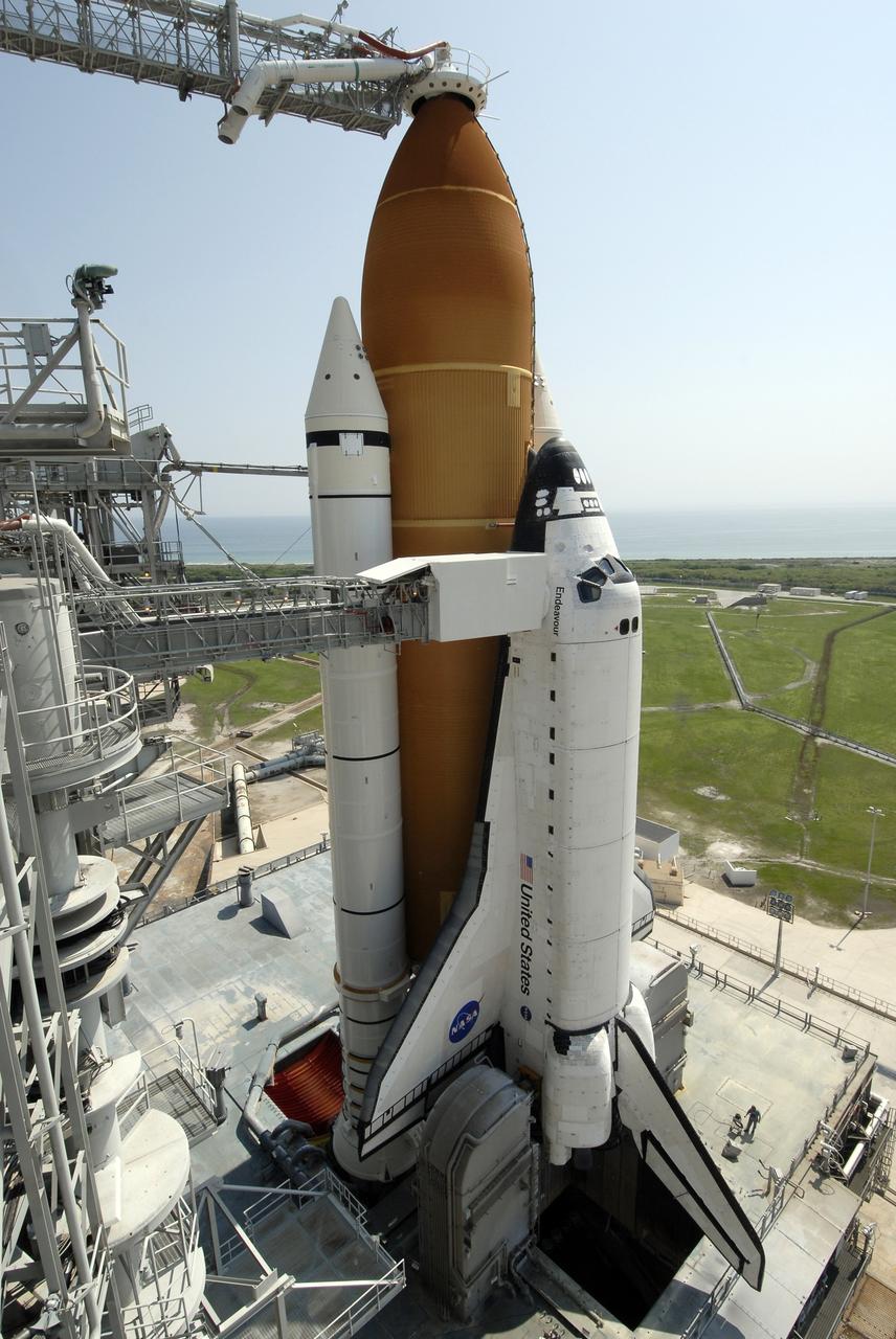 CAPE CANAVERAL, Fla. –  After rollback of the rotating service structure, or RSS, on Launch Pad 39A at NASA's Kennedy Space Center in Florida, space shuttle Endeavour is closer to launch.  Above the external tank is the "beanie cap," the oxygen vent hood that is designed to vent gaseous oxygen vapors away from the shuttle.  At center against Endeavour's cockpit is seen the White Room at the end of the orbiter access arm.  The White Room provides the astronauts entry into the shuttle.  Endeavour sits on the mobile launcher platform, which straddles the flame trench below.  On either side of the engine nozzles are the tail masts, which provide several umbilical connections to the orbiter, including a liquid-oxygen line through one and a liquid-hydrogen line through another. First motion of the RSS was at 10:15 a.m. EDT. The rollback is in preparation for Endeavour's liftoff on the STS-127 mission with a crew of seven.  This is the second launch attempt for Endeavour after the June 13 launch was scrubbed due to a hydrogen leak at the Ground Umbilical Carrier Plate during tanking June 12.  The launch will be Endeavour's 23rd flight. The shuttle will carry the Japanese Experiment Module's Exposed Facility, or JEM-EF, and the Experiment Logistics Module-Exposed Section, or ELM-ES, on STS-127. The mission is the final of three flights dedicated to the assembly of the Japan Aerospace Exploration Agency's Kibo laboratory complex on the space station. Endeavour's launch is scheduled for June 17 at 5:40 a.m. EDT.  Photo credit: NASA/Kim Shiflett