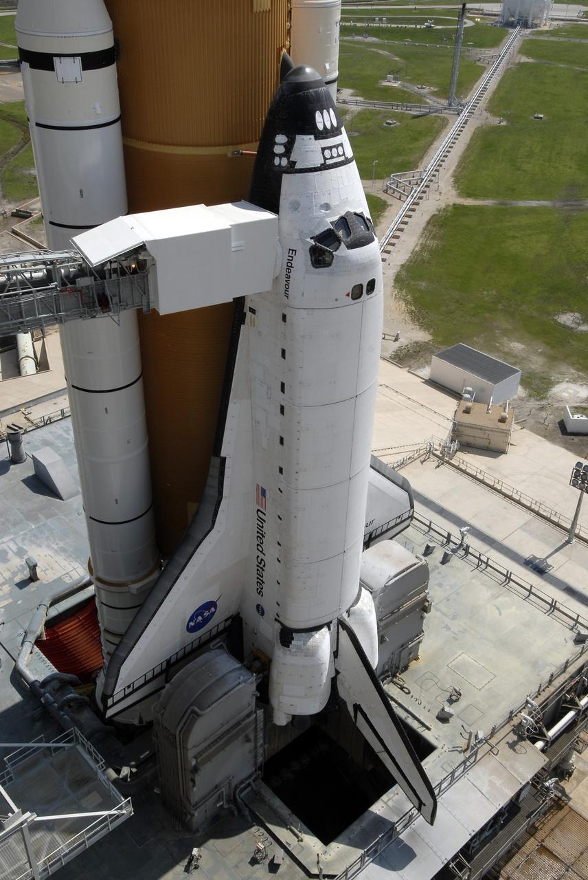 CAPE CANAVERAL, Fla. –  After rollback of the rotating service structure, or RSS, on Launch Pad 39A at NASA's Kennedy Space Center in Florida, space shuttle Endeavour is closer to launch.  Against Endeavour's cockpit is seen the White Room at the end of the orbiter access arm.  The White Room provides the astronauts entry into the shuttle.  Endeavour sits on the mobile launcher platform, which straddles the flame trench below.  On either side of the engine nozzles are the tail masts, which provide several umbilical connections to the orbiter, including a liquid-oxygen line through one and a liquid-hydrogen line through another. First motion of the RSS was at 10:15 a.m. EDT. The rollback is in preparation for Endeavour's liftoff on the STS-127 mission with a crew of seven.  This is the second launch attempt for Endeavour after the June 13 launch was scrubbed due to a hydrogen leak at the Ground Umbilical Carrier Plate during tanking June 12.  The launch will be Endeavour's 23rd flight. The shuttle will carry the Japanese Experiment Module's Exposed Facility, or JEM-EF, and the Experiment Logistics Module-Exposed Section, or ELM-ES, on STS-127. The mission is the final of three flights dedicated to the assembly of the Japan Aerospace Exploration Agency's Kibo laboratory complex on the space station. Endeavour's launch is scheduled for June 17 at 5:40 a.m. EDT.  Photo credit: NASA/Kim Shiflett