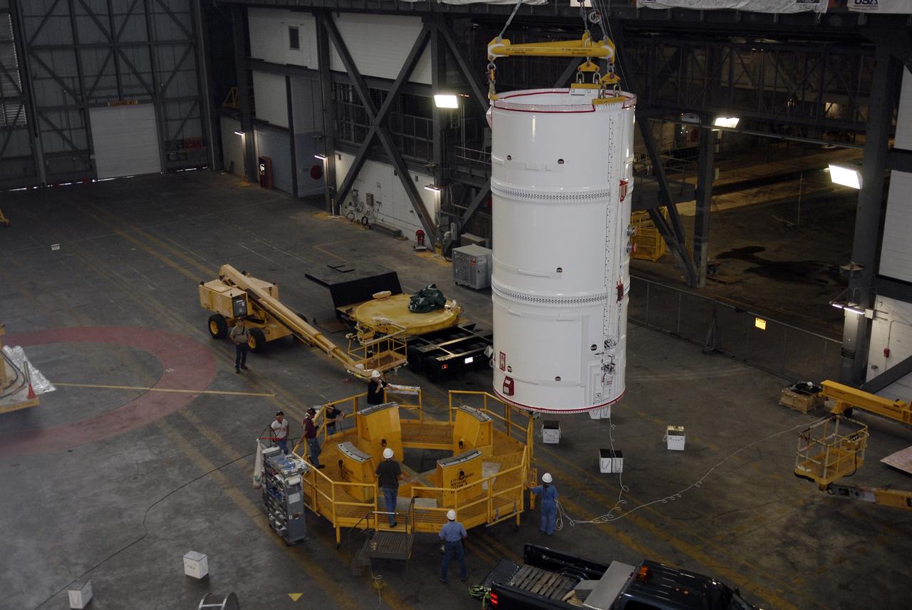 CAPE CANAVERAL, Fla. – The Ares I-X fifth segment simulator assembly is being lifted toward a stand in the Vehicle Assembly Building's transfer aisle at NASA's Kennedy Space Center in Florida. The assembly will later be lifted into the VAB's High Bay 4. Ares I-X is the flight test vehicle for the Ares I, the essential core of a safe, reliable, cost-effective space transportation system that eventually will carry crewed missions back to the moon, on to Mars and out into the solar system. Ares I-X is targeted for launch in August 2009. Photo credit: NASA/Kim Shiflett