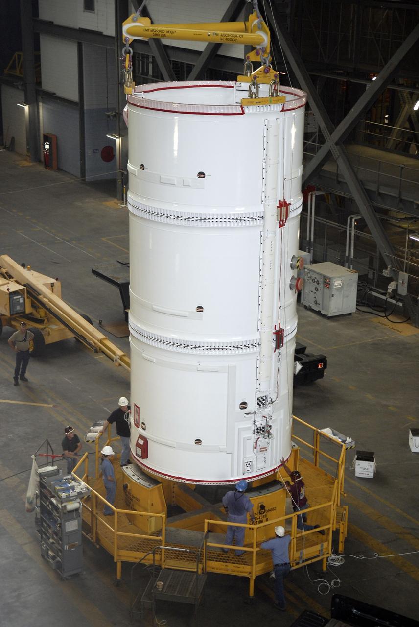 CAPE CANAVERAL, Fla. – The Ares I-X fifth segment simulator assembly is lowered onto a stand in the Vehicle Assembly Building's transfer aisle at NASA's Kennedy Space Center in Florida. The assembly will later be lifted into the VAB's High Bay 4. Ares I-X is the flight test vehicle for the Ares I, the essential core of a safe, reliable, cost-effective space transportation system that eventually will carry crewed missions back to the moon, on to Mars and out into the solar system. Ares I-X is targeted for launch in August 2009. Photo credit: NASA/Kim Shiflett