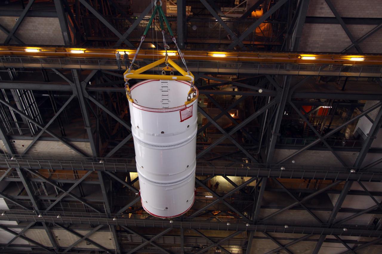 CAPE CANAVERAL, Fla. –  In the Vehicle Assembly Building at NASA's Kennedy Space Center in Florida, the Ares I-X fifth segment simulator assembly is lifted from the transfer aisle.  It will be moved into High Bay 4 with other Ares I-X segments. Ares I-X is the flight test vehicle for the Ares I,  the essential core of a safe, reliable, cost-effective space transportation system that eventually will carry crewed missions back to the moon, on to Mars and out into the solar system. Ares I-X is targeted for launch in August 2009.   Photo credit: NASA/Kim Shiflett