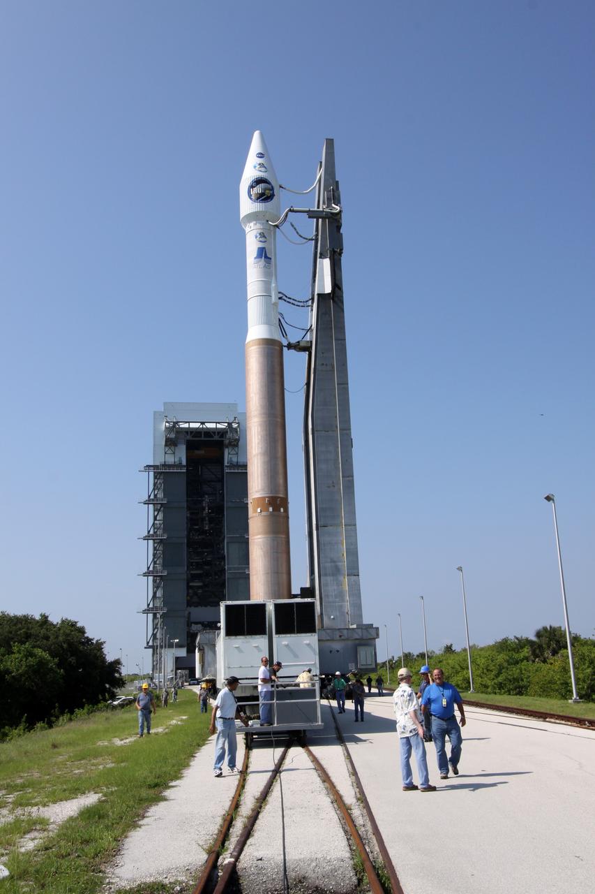 CAPE CANAVERAL, Fla. –   On Launch Complex-41 on Cape Canaveral Air Force Station in Florida,  workers accompany NASA's Lunar Reconnaissance Orbiter, or LRO, and NASA's Lunar Crater Observation and Sensing Satellite, known as LCROSS, plus launch gantry as they roll out to the launch pad.  The satellites are atop their launch vehicle, the Atlas V/Centaur rocket.   LRO and LCROSS are the first missions in NASA's plan to return humans to the moon and begin establishing a lunar outpost by 2020. The LRO also includes seven instruments that will help NASA characterize the moon's surface:  DIVINER, LAMP, LEND, LOLA, CRATER, Mini-RF and LROC.   Launch is scheduled for 5:22 p.m. EDT June 18 . Photo credit: NASA/Jack Pfaller